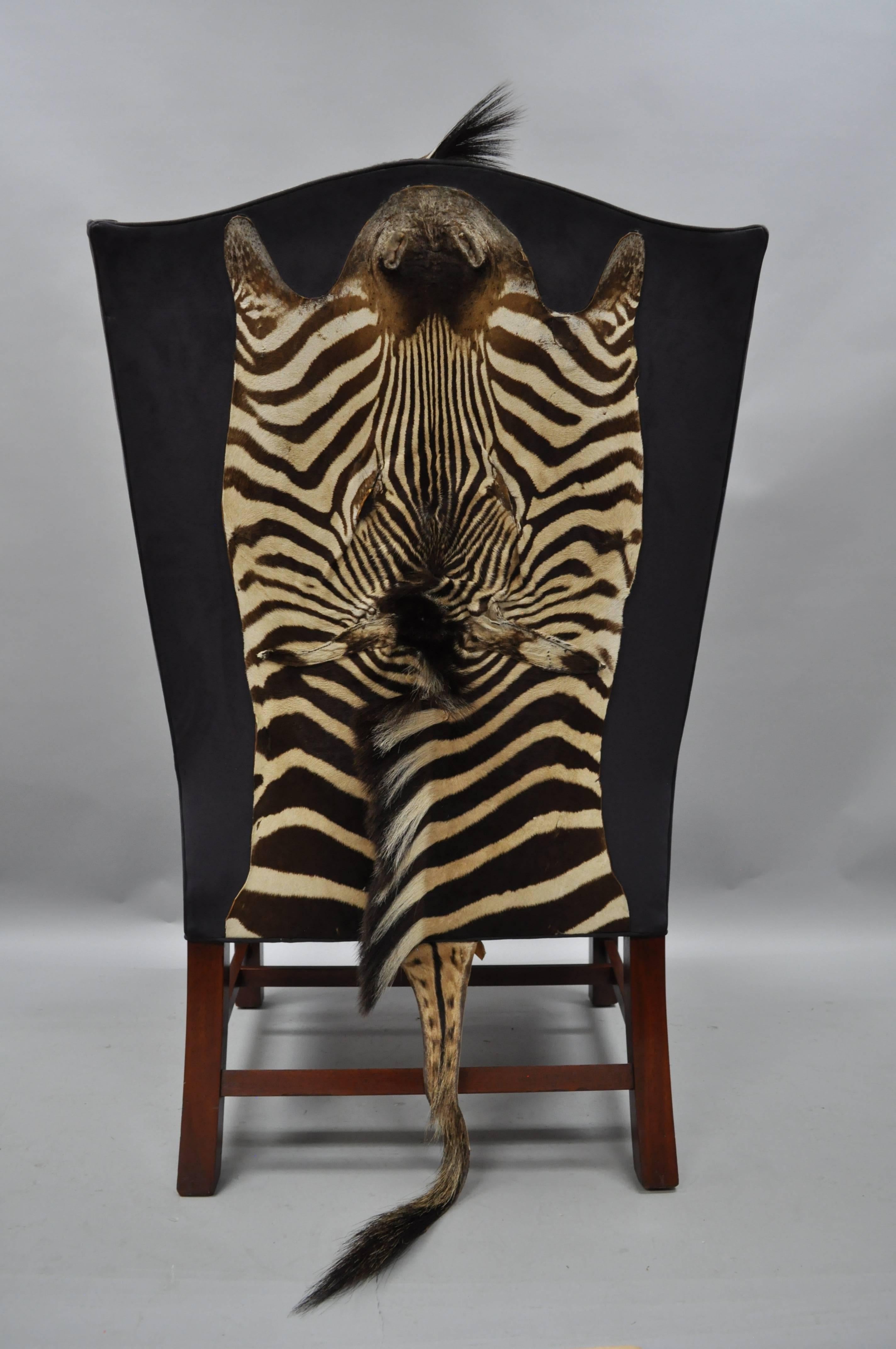 High quality custom-made English Georgian style mahogany wingback library chair with zebra hide / taxidermy zebra head (to rear) with blue suede upholstery. Item features a heavy solid wood frame, rolled arms, shaped wing back, with blue suede and