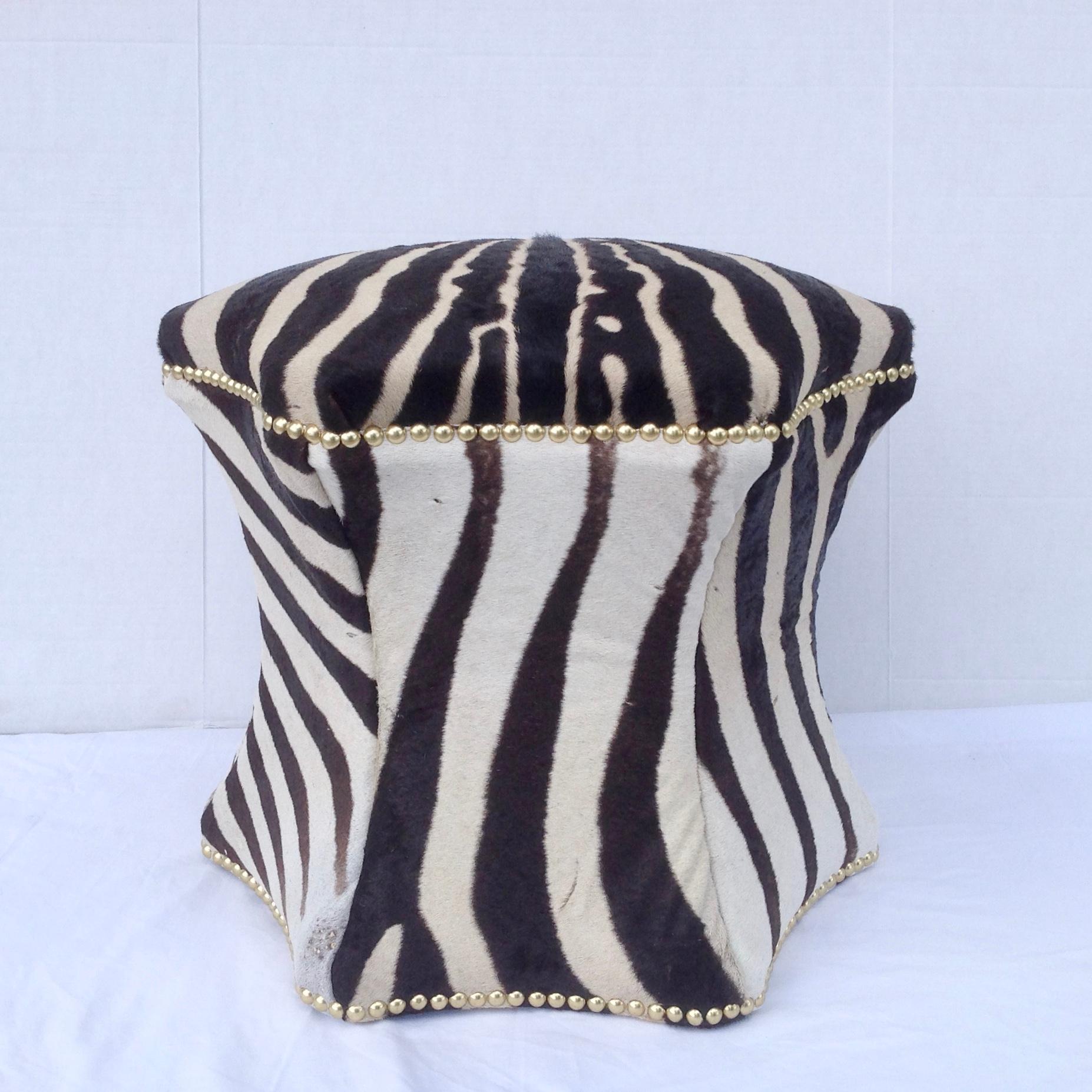 Beautifully fashioned from an entire zebra hide and appointed with brass nail head trim.
A custom made piece of unusual form.