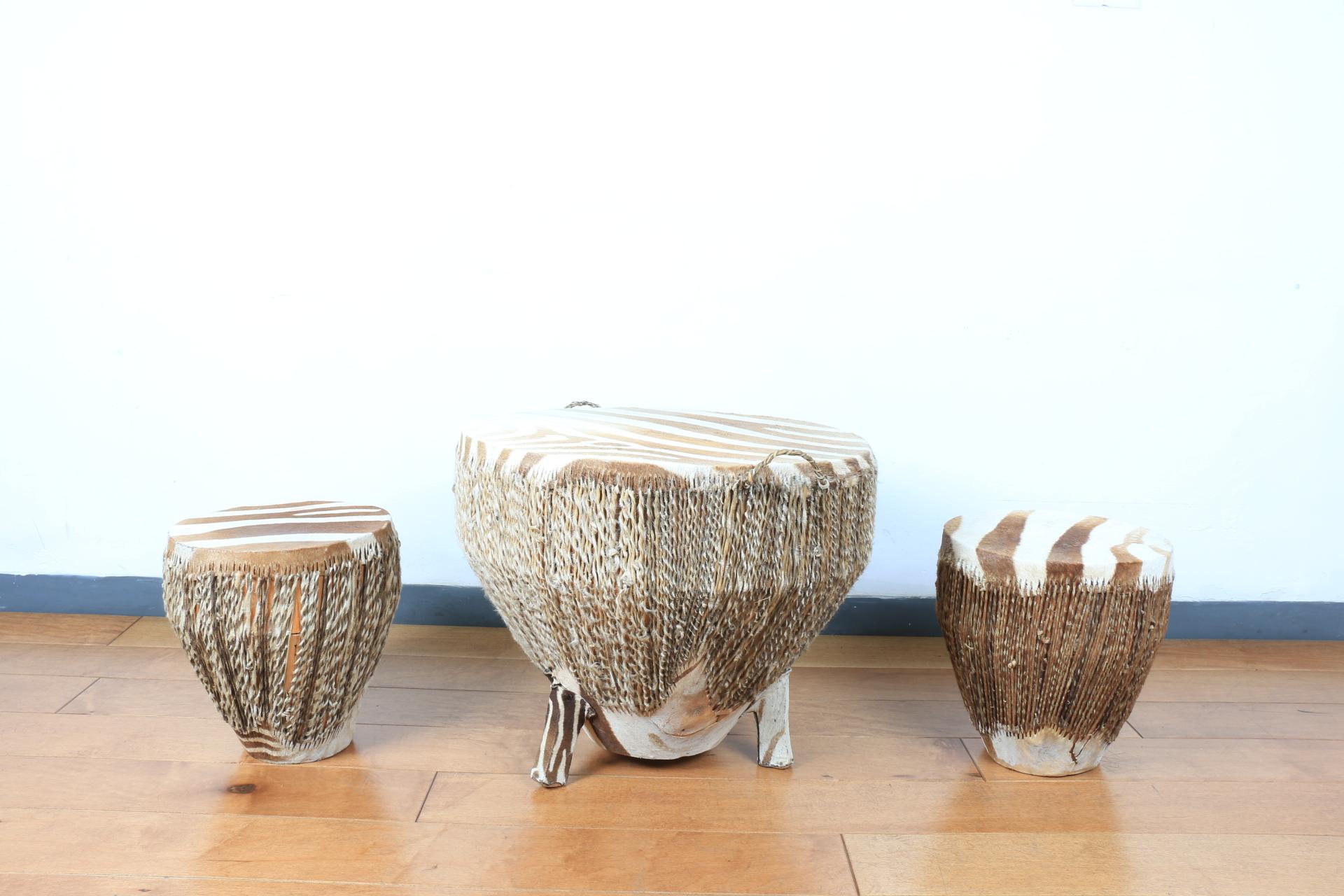 Vintage small low drum style table with drum zebra stools. All are well kept. All handles are also well kept. They are all lightweight. Great statement pieces to any home.