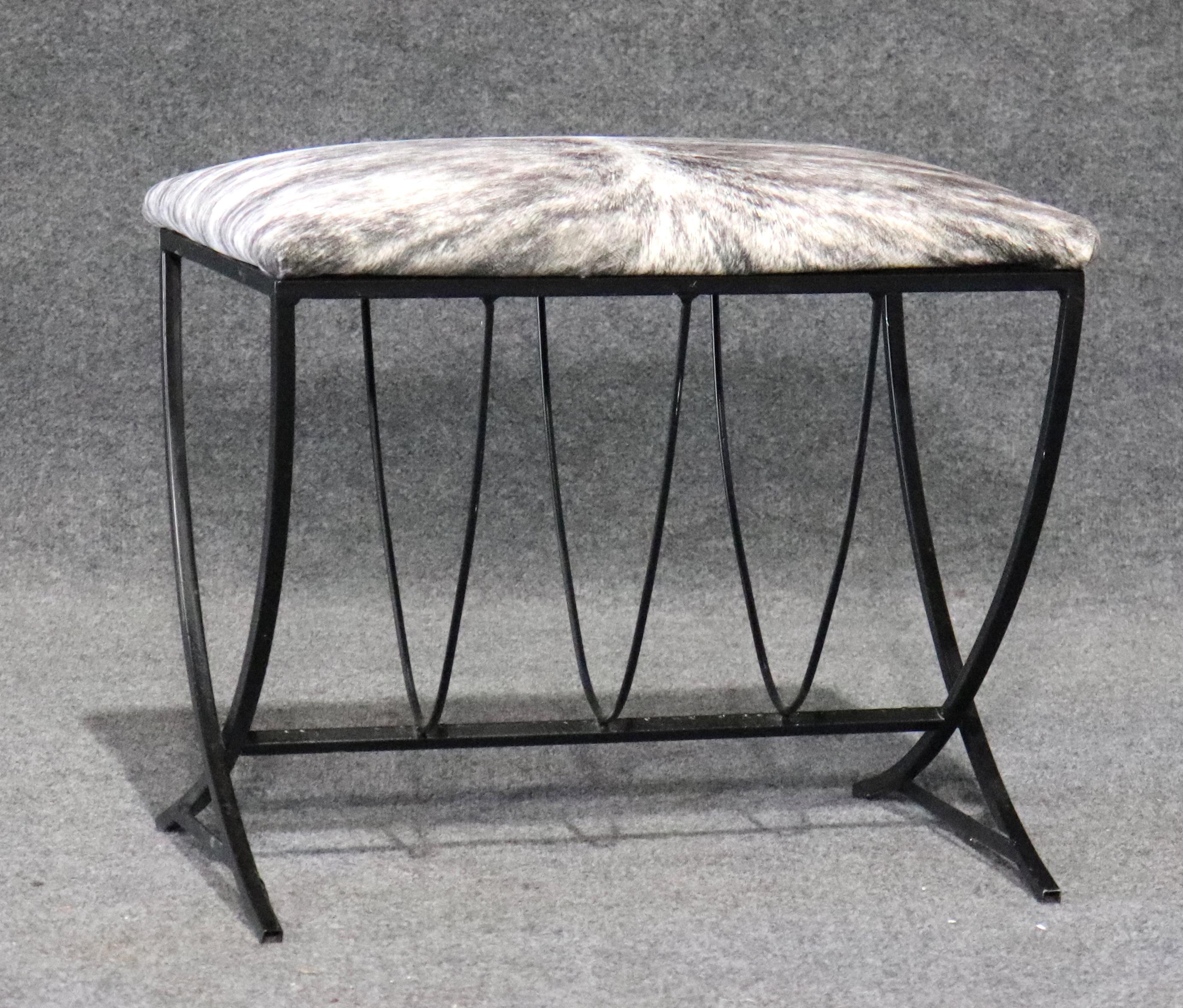 Wrought iron metal base in black with attractive criss cross lines. Faux zebra hide cushioned seat.
Please confirm location.