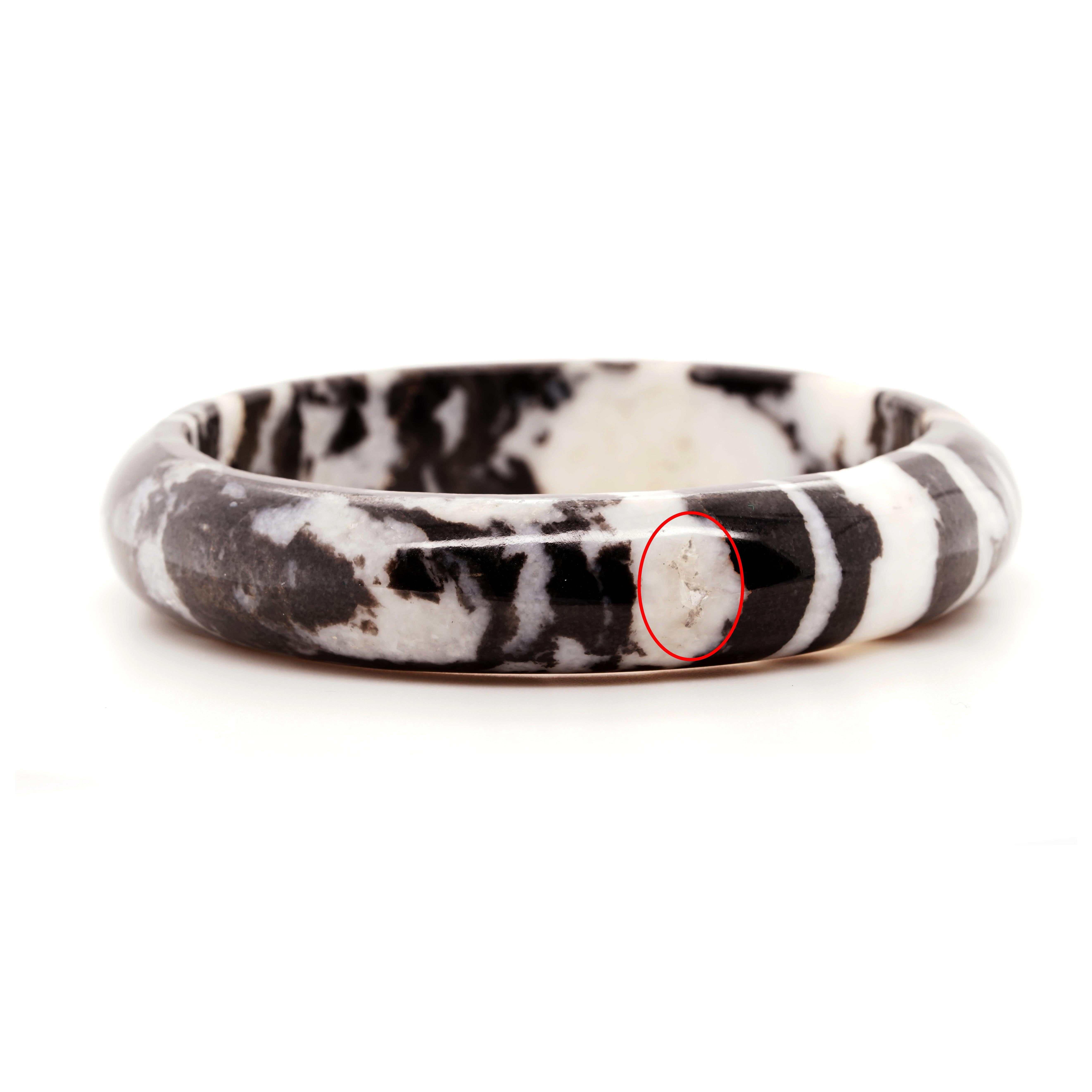 The Zebra Jasper Bangle is characterised by its striking black and white banding reminiscent of a zebra's stripes. The unique inclusions on the stone show their great age and natural beauty. Whether worn alone as a focal point or stacked with other