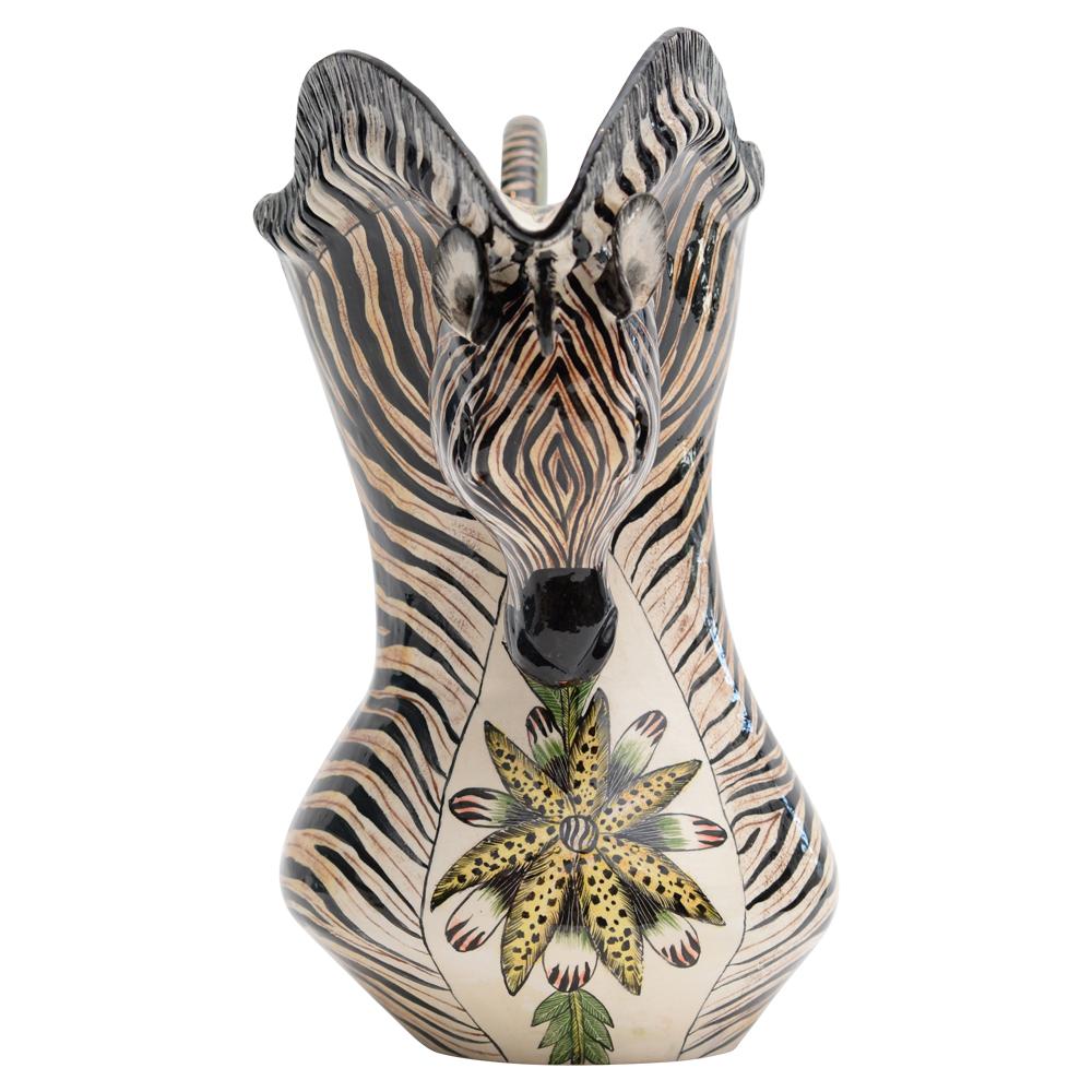 This remarkable Zebra Jug by Ardmore Ceramics is a true testament to the artistry of South Africa and a showcase of deep admiration for this noble animal. Hand-sculpted by the skilled hands of Somandla Ntshalintshali and brought to life with