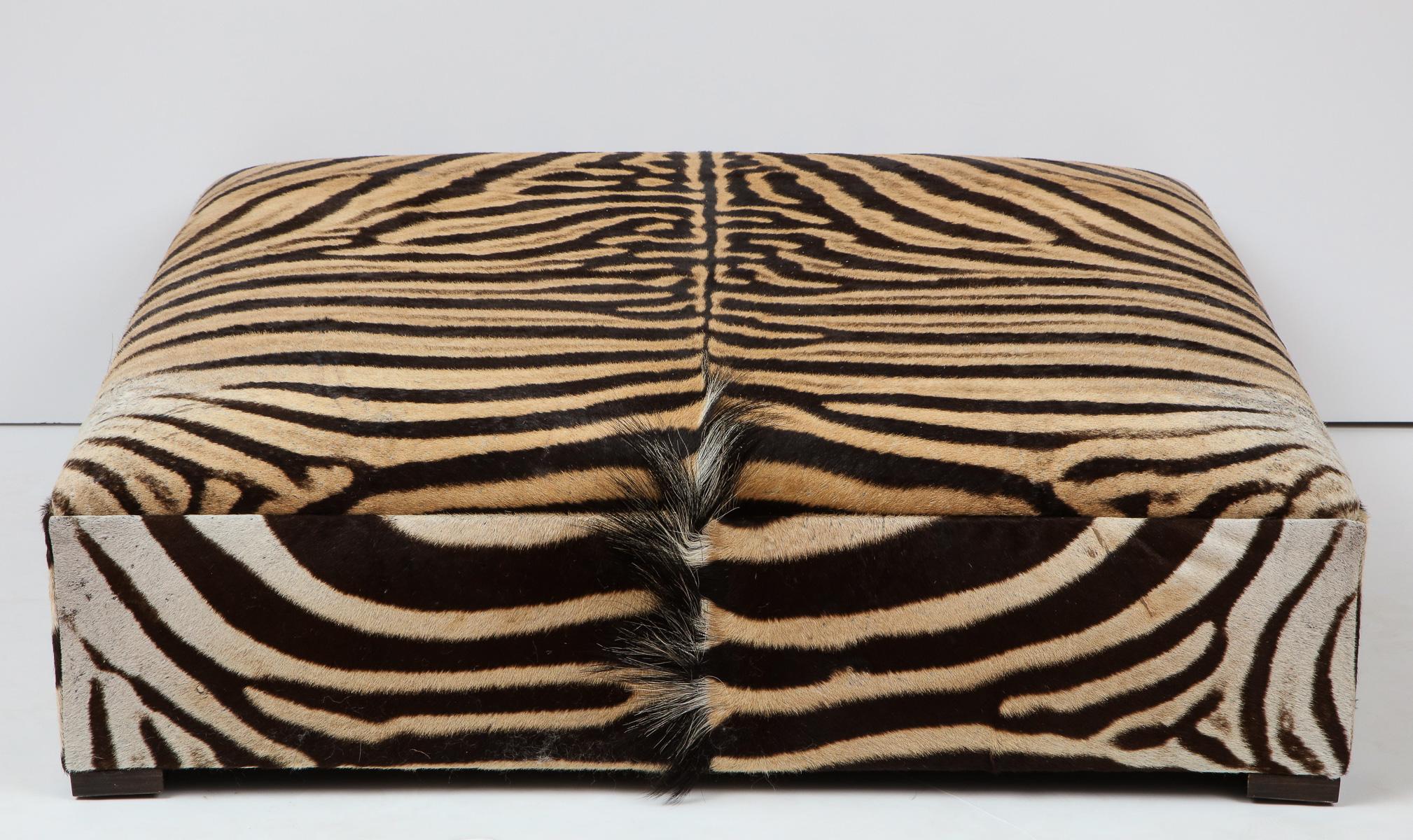 Large zebra ottoman, measures: 42 inches by 42 inches and 14 inches high. Great as a coffee table or ottoman. Built in our NJ factory.
Made of beautiful zebra hides from South Africa.
This ottoman is sold but we have another one in stock. Please