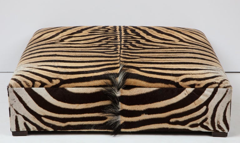 Large zebra ottoman, measures: 42 inches by 42 inches and 17 inches high. Great as a coffee table or ottoman. Built in our NJ factory.
Made of beautiful zebra hides from South Africa.
This ottoman is sold but we have another one in stock. Please