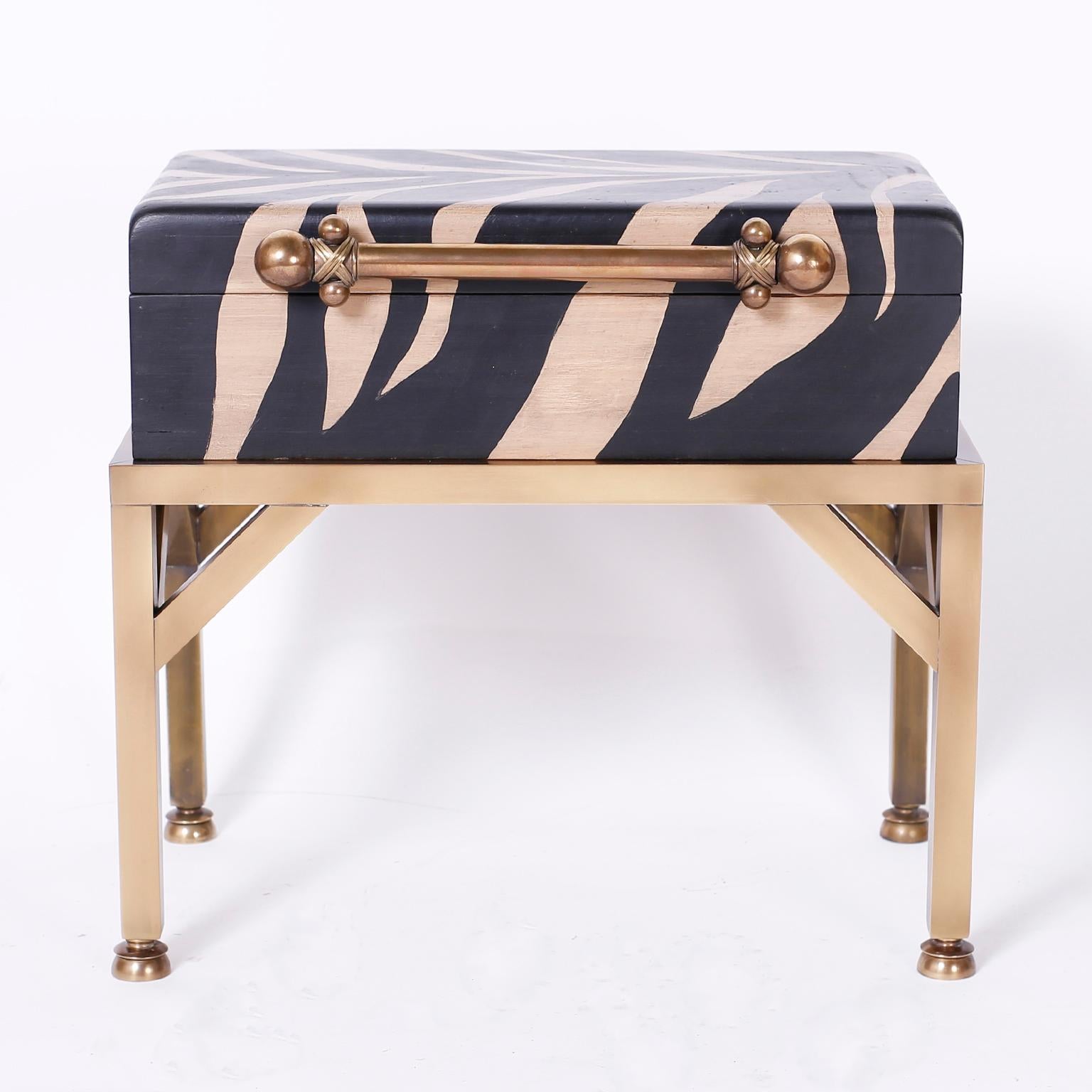 Midcentury lidded wood box decorated in faux zebra paint with a decorative handle and set on a burnished brass stand.