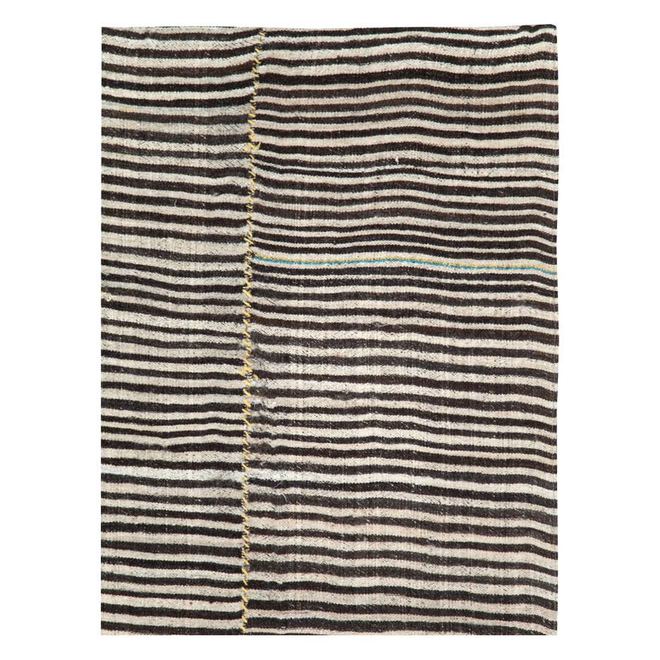 A vintage Persian flatweave Kilim accent rug in gallery format, with a zebra print design, handmade during the mid-20th century.

Measures: 5' 3