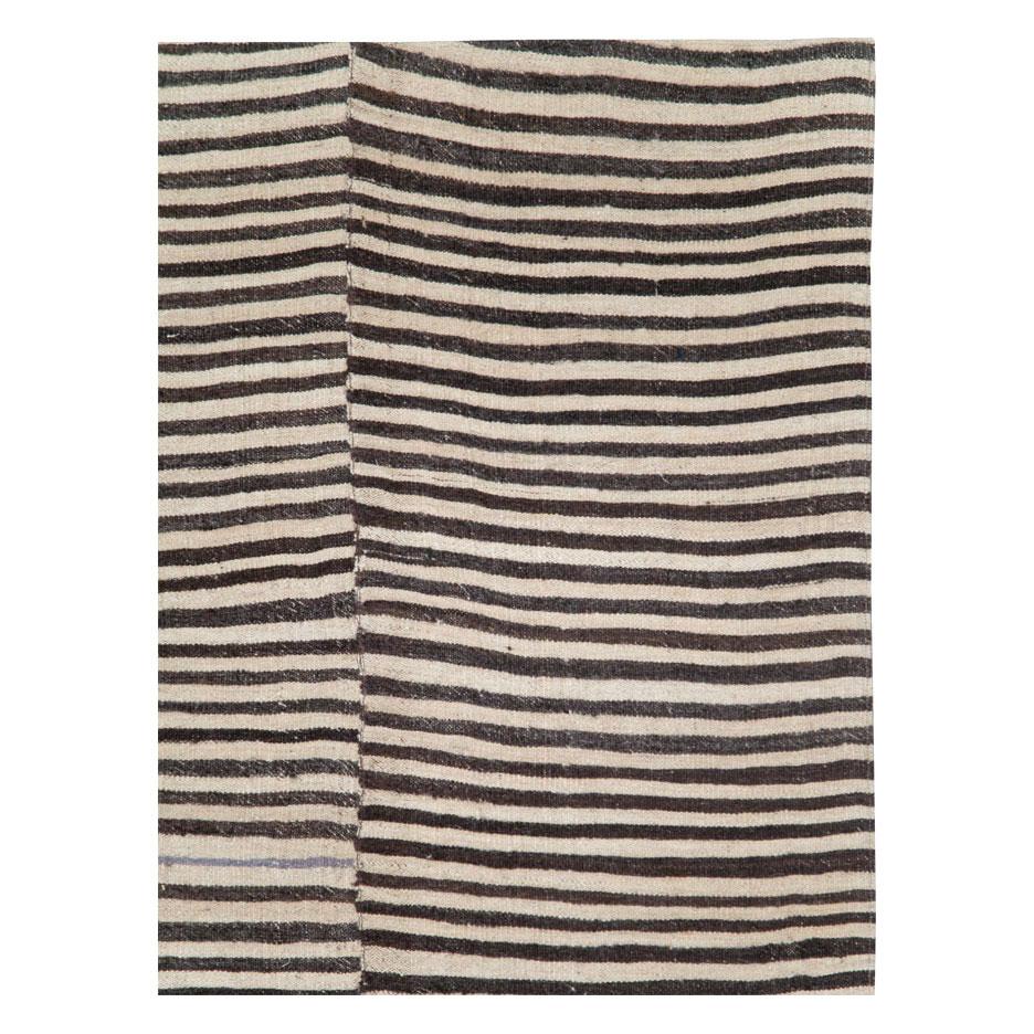 A vintage Persian flatweave Kilim accent rug, with a zebra print design, handmade during the mid-20th century.

Measures: 5' 3