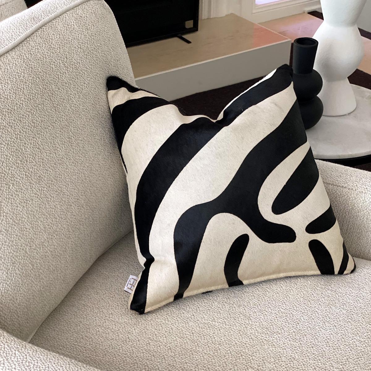 Add exotic flair to your interiors with this zebra print pillow.  Australian Designer and Artisan, Emily Barbara personally pre-selects and pre-patterns the zebra print cowhide skins to capture the striking pattern and color tones prior to creating