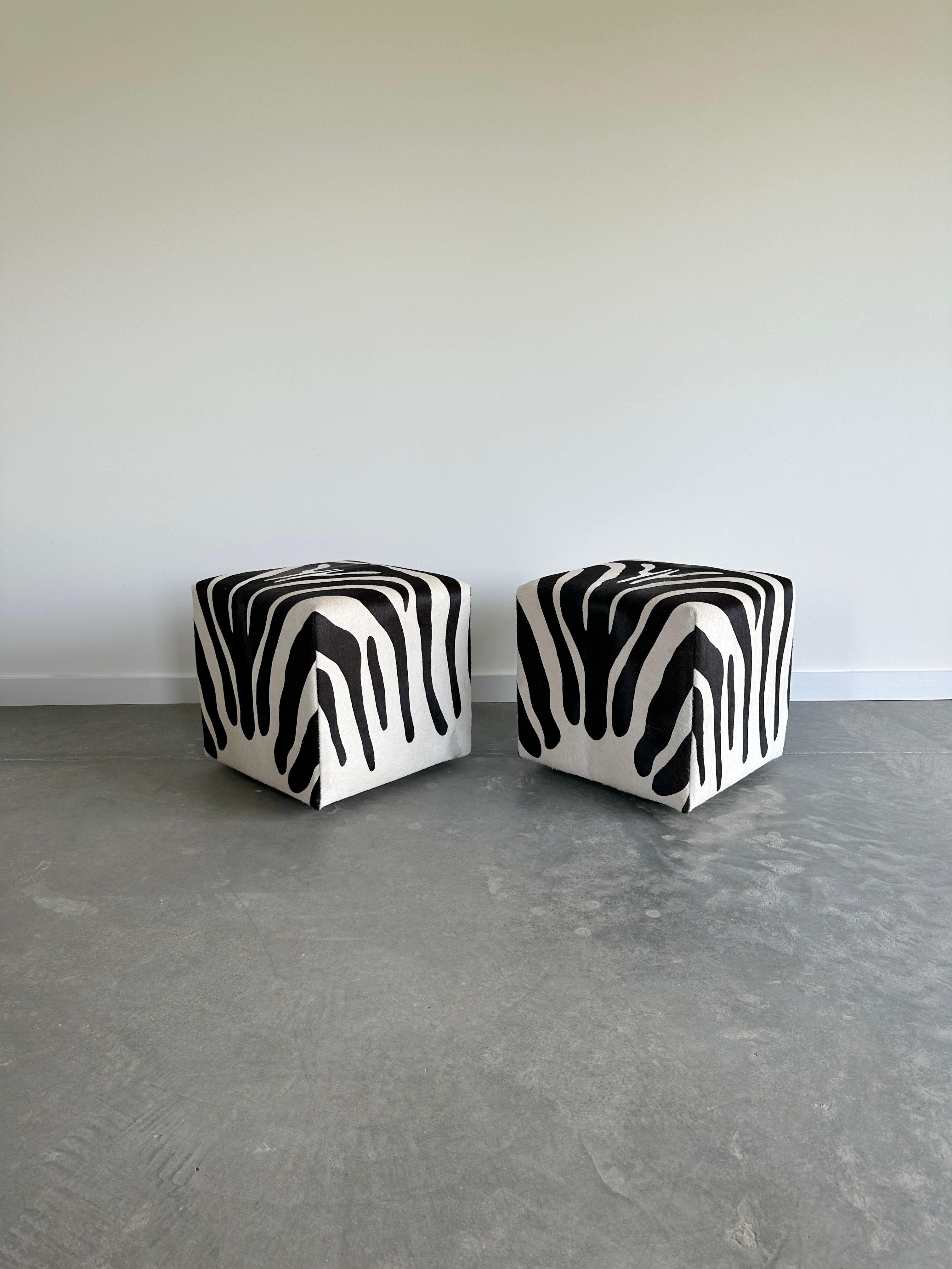 Discontinued style by Design Within Reach. Padded ottoman cube on castors upholstered in zebra design printed on pony hair leather. Essentially unused condition.