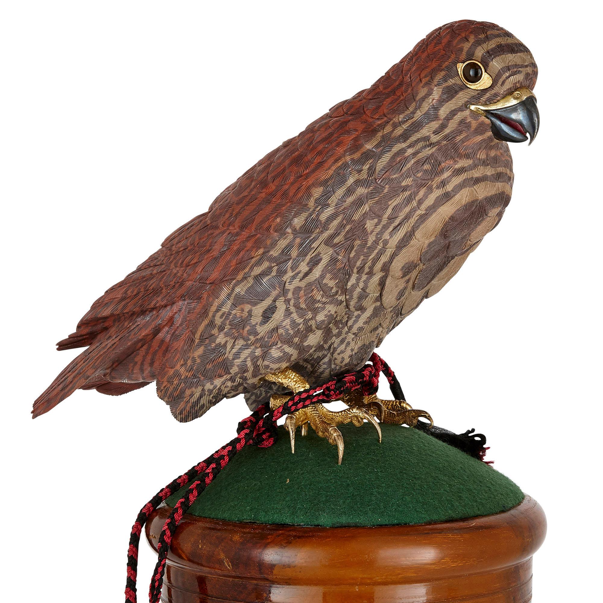 Zebra stone and vermeil model of a hawk
Continental, 20th century
Measures: Height 58cm, diameter 25cm

This bird model depicts a hawk perched atop a rest. The body of the hawk, which is realistically carved from zebra stone, is mounted with