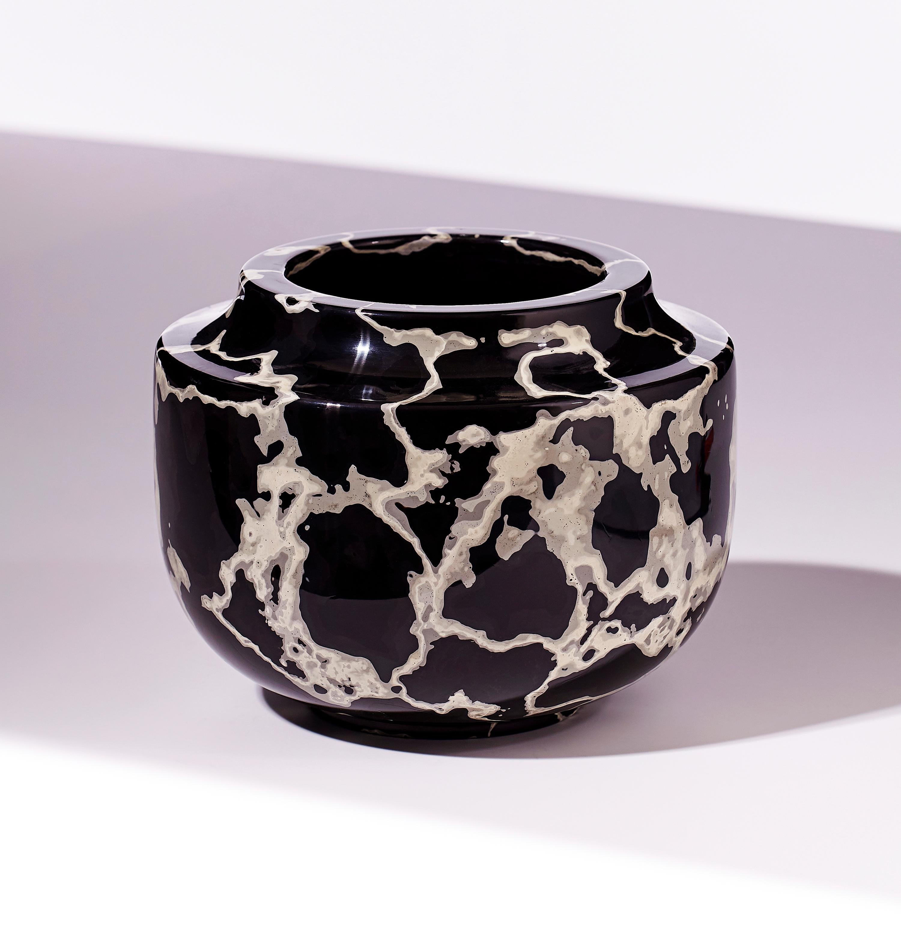 This vessel is created by applying multiple coats of Jesmonite (plaster) in a three dimensional landscape of textured surfaces. Each calculated coat of colour is eventually revealed by carving and lathing though the final mass of layers. Once