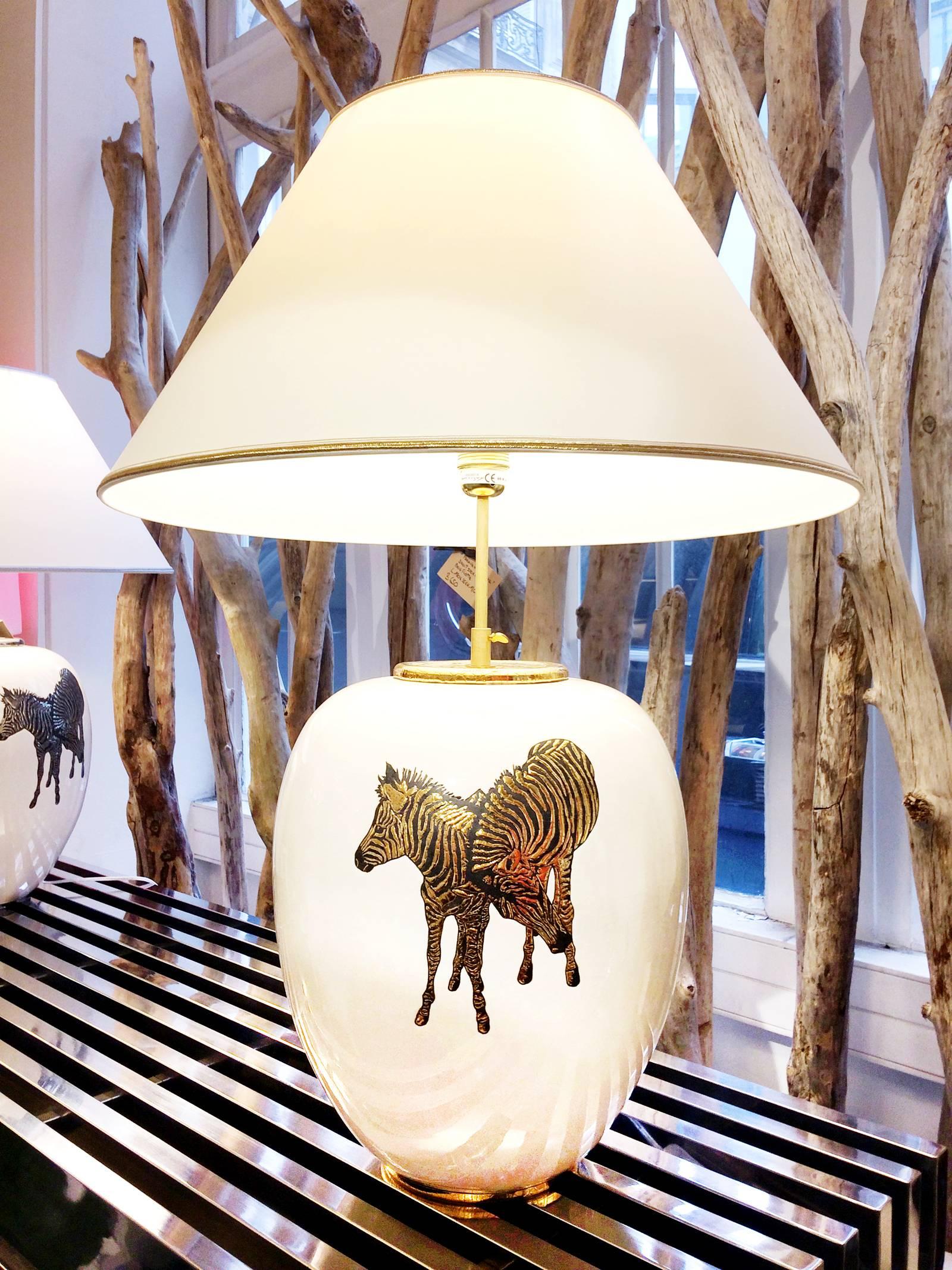 Table lamp zebra in Emaux de Longwy,
earthenware from France. With four golded zebra,
Exceptional piece. Available with four silvered zebra.
Measures: Shade diameter 56 x height 75 cm.
Base diameter 30 x height 38 cm.

   