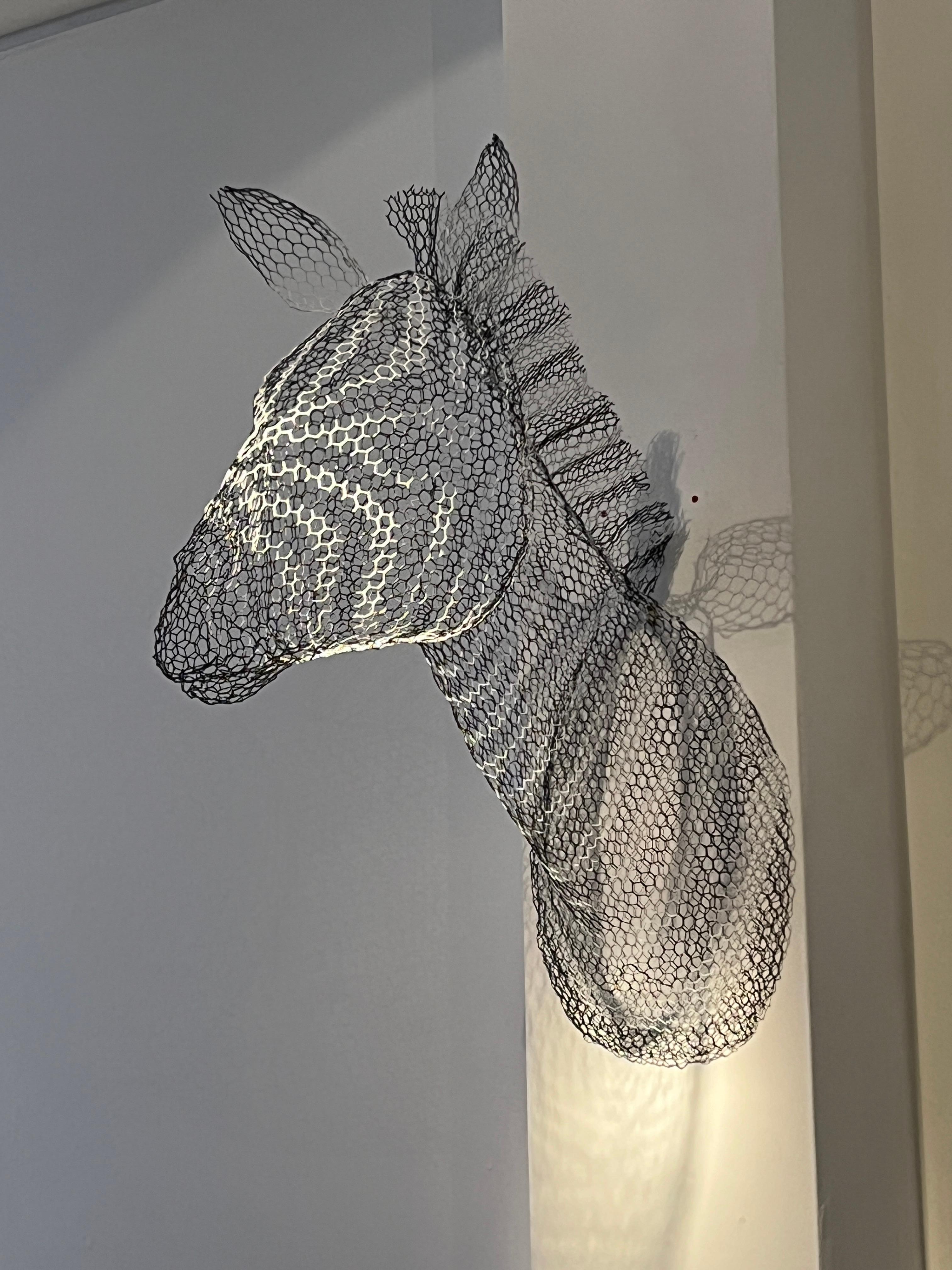 Life-sized, impressive hand-formed sculpture of a zebra head, finished in black and white enamel paint.