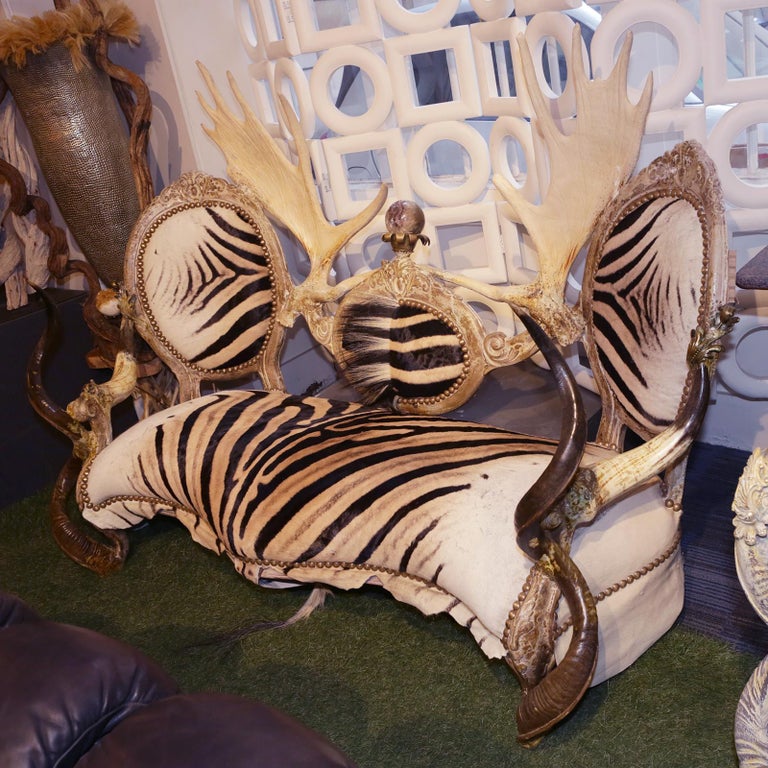 Sofa Zebra with Médaillons with structure in solid beech wood,
upholstered and covered with Burchell zebra natural skin, with
3 backrest covered too with Burchell zebra natural skin. backrest
is ornamented with 2 natural reindeer antlers, armrest