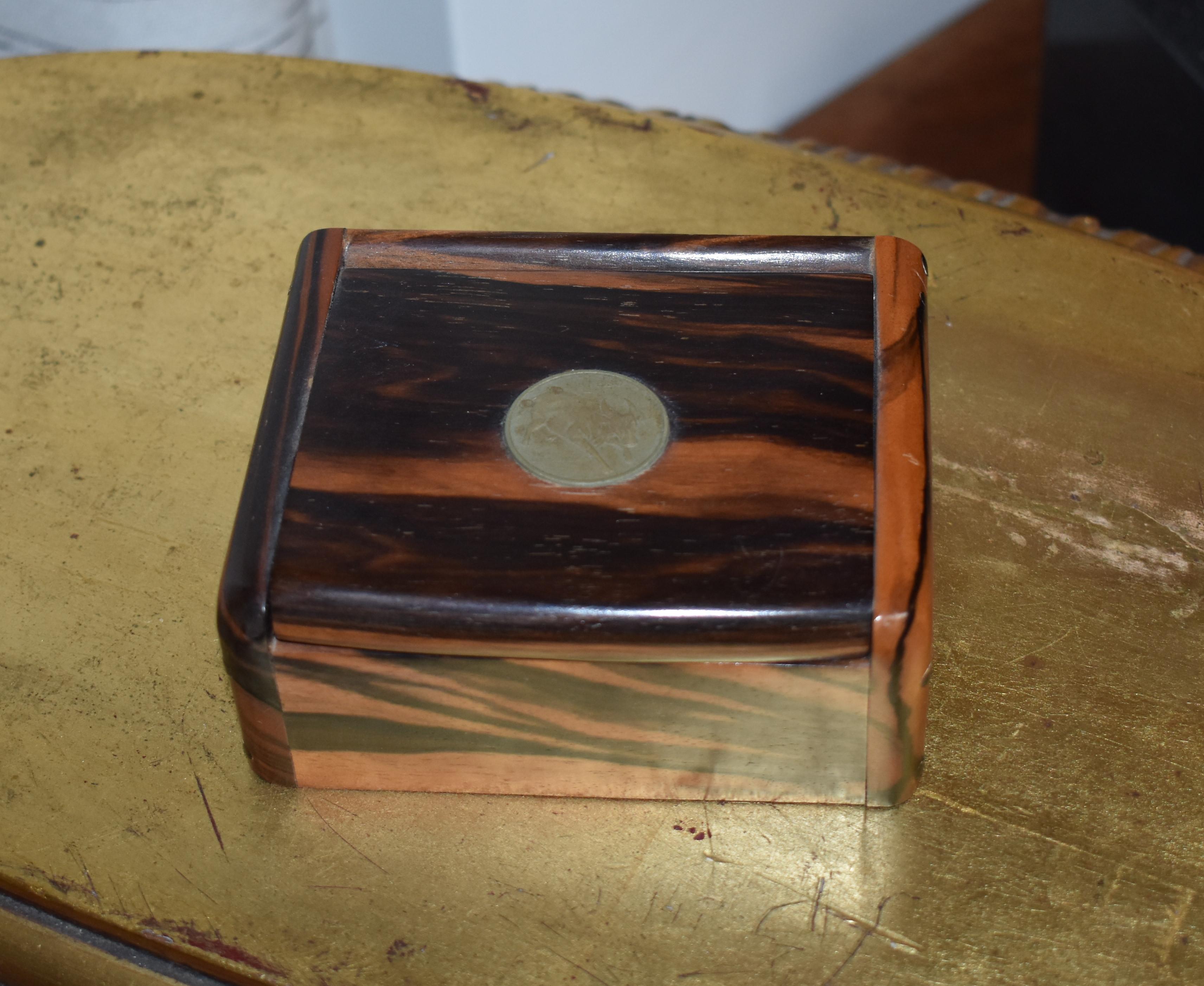 Small elegant jewelry zebra box with A Peso coin.