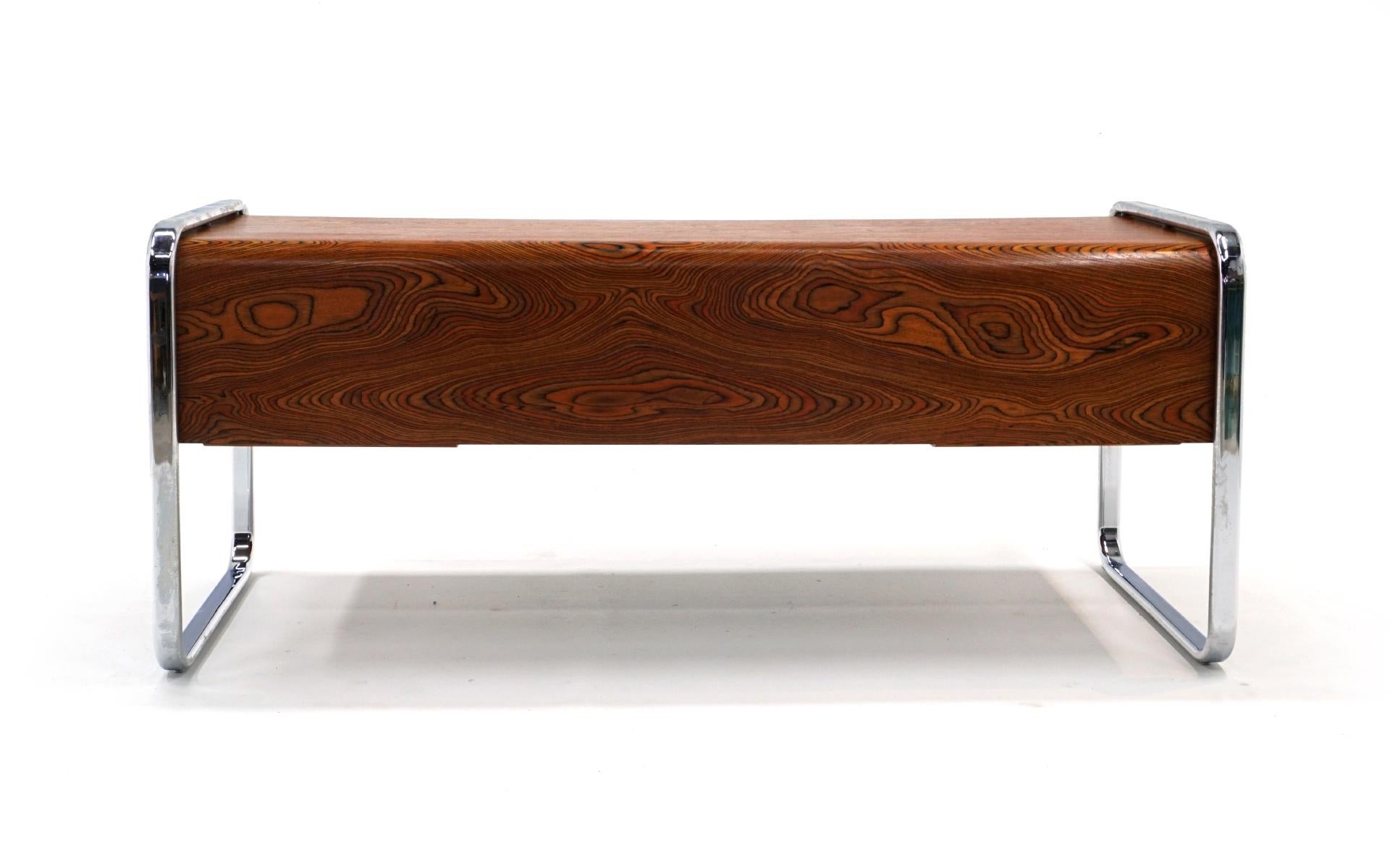 Peter Protzman desk designed in the 1970s and produced for only a short time due to production costs. The multi-color figuring in the zebra wood is absolutely stunning. Shockingly good original condition. Virtually no scratches on the desk, light