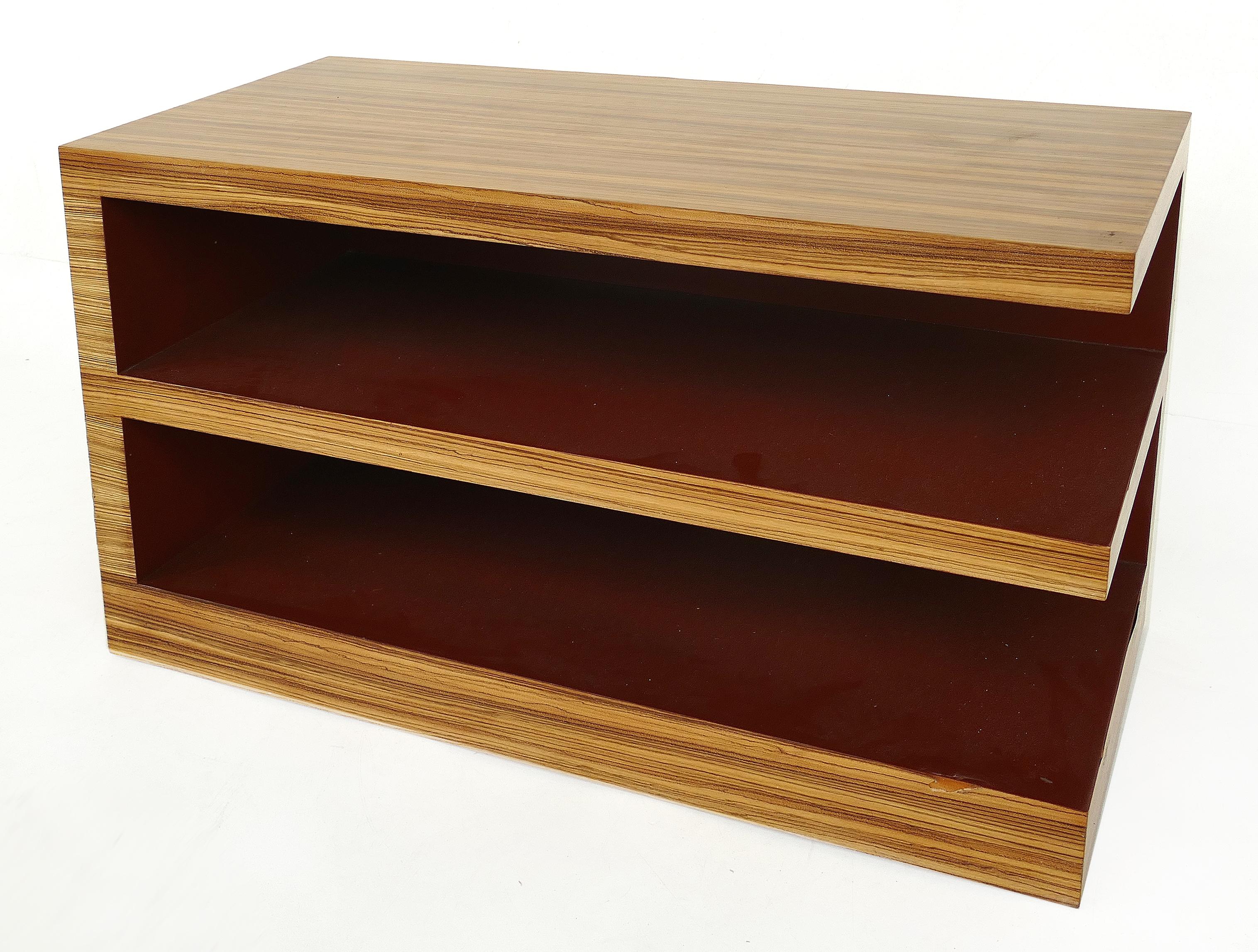 Zebra wood tiered low bookcase side or end table

Offered for sale is a low zebra wood tiered bookcase side or end table with laminated interior shelves. The piece can float within a room as it is finished on all sides.