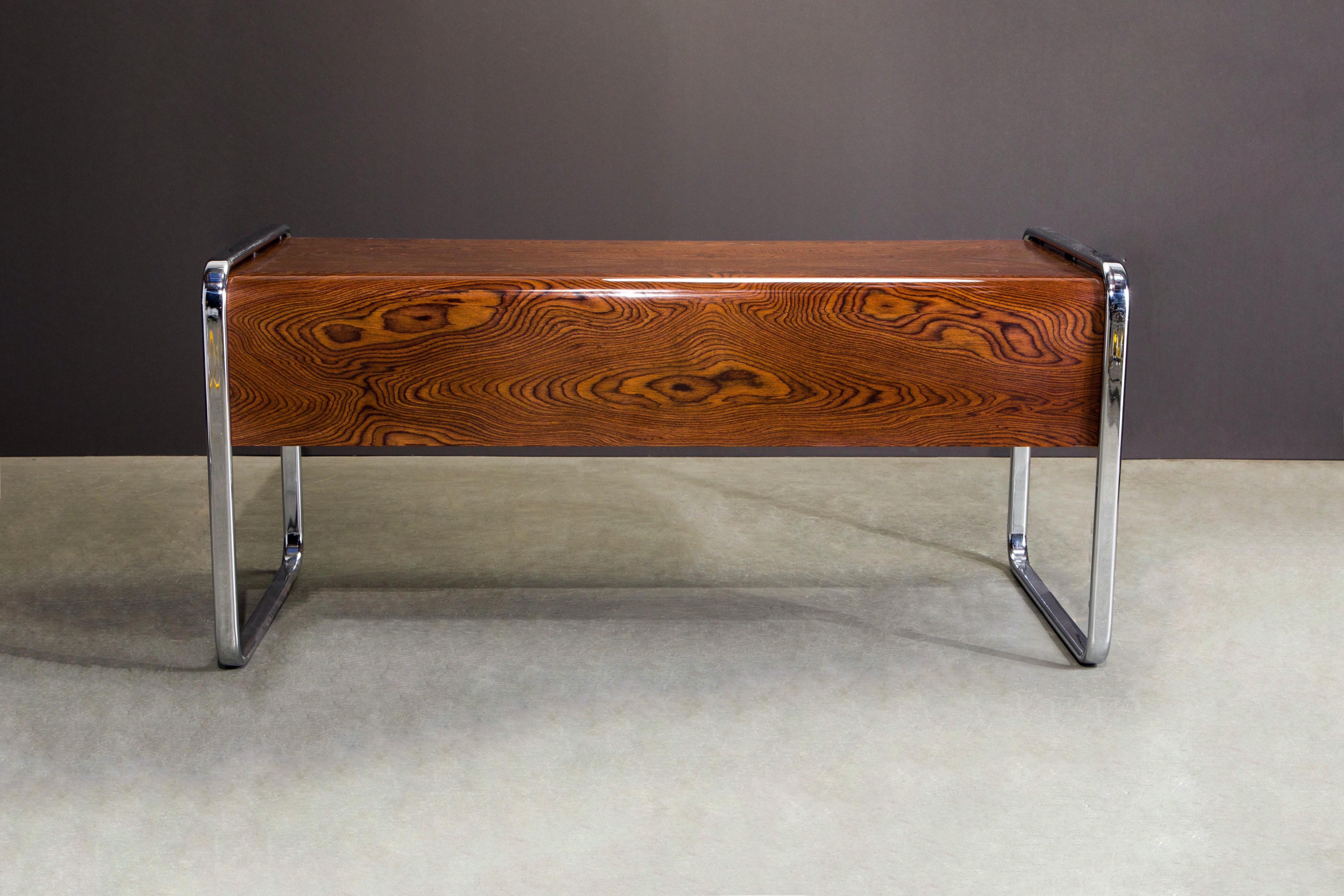 A beautifully restored Peter Protzmann for Herman Miller desk in exotic African Zebrawood, circa 1970s, and chrome legs which wrap around over the top. Made in limited quantities, this desk is quite rare and sought-after and within the last few