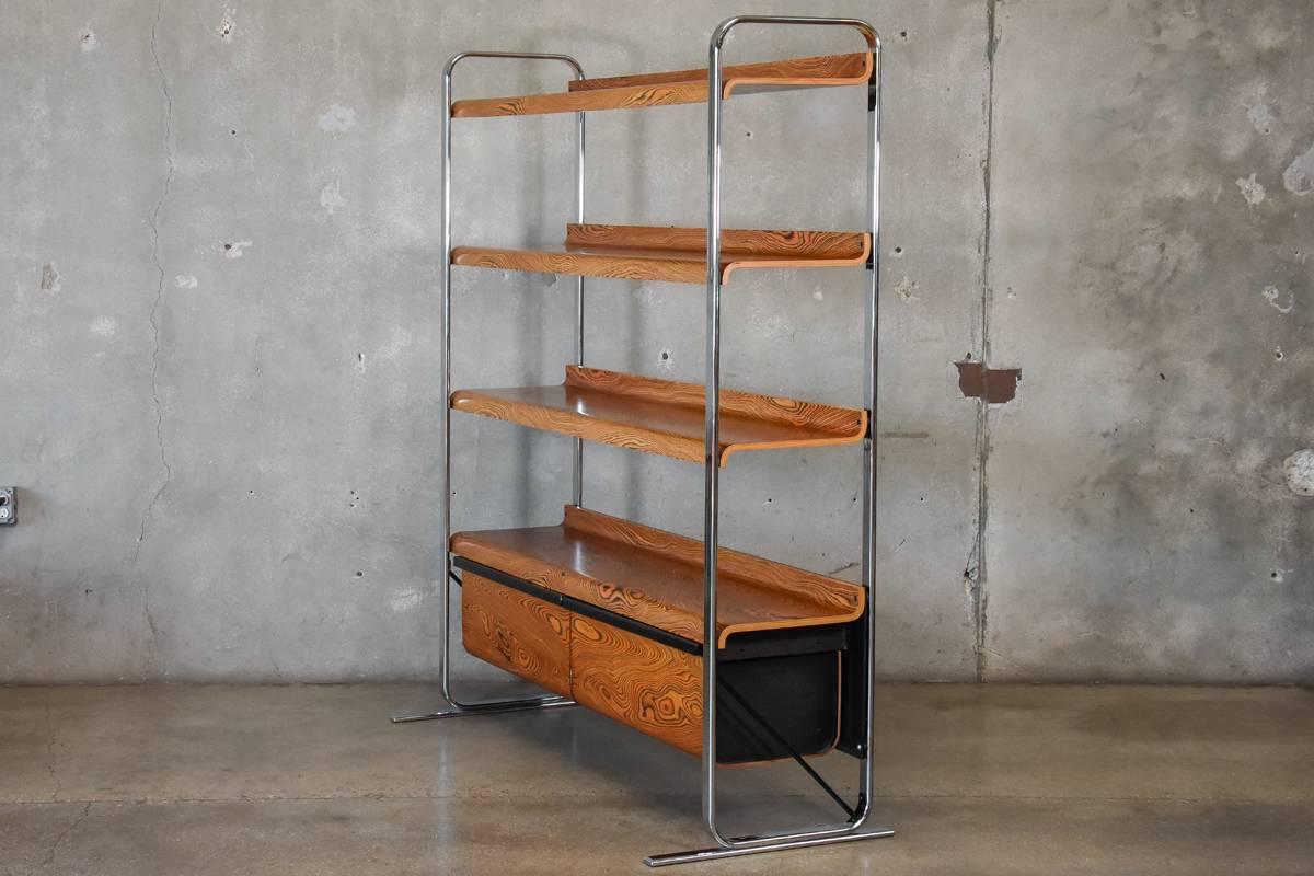A beautiful zebrawood and chrome shelf unit from the Tubular collection designed by Peter Protzman for Herman Miller and manufactured for only one year between 1970-1971. This dramatic piece features zebrawood veneered shelves and drawers suspended