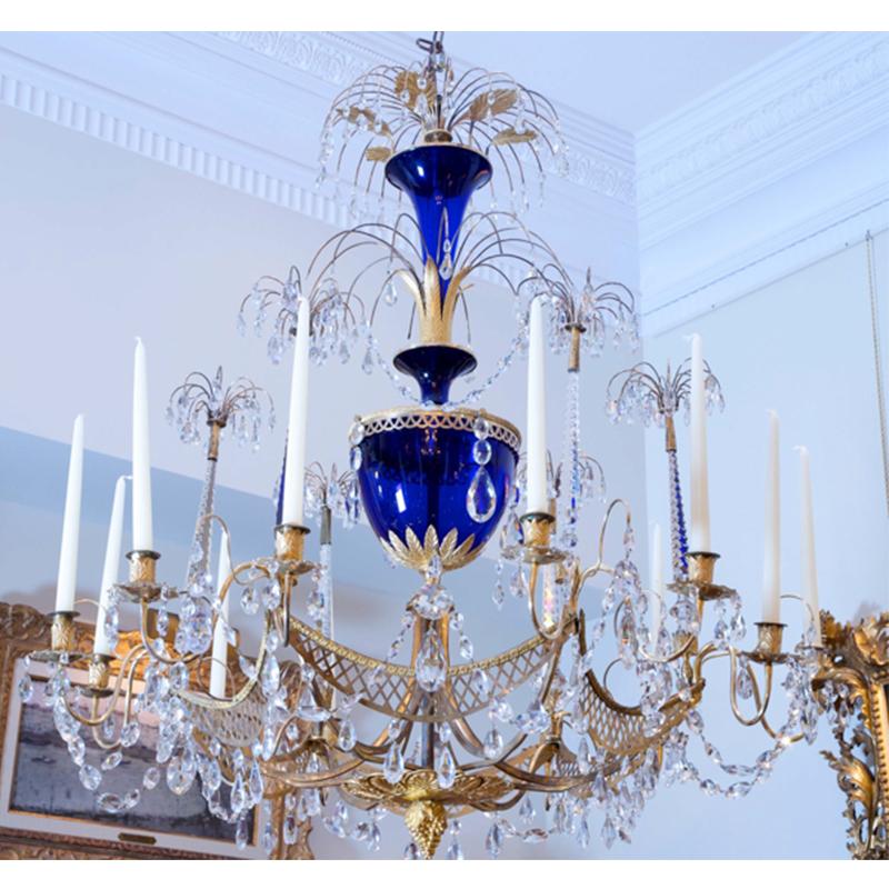 A rare and important Russian 18th century twelve-candle chandelier attributed to the firm of Zech from St. Petersberg, Russia. Comprised of a cobalt blue glass central stem, gilded bronze palmettes, swags, and other gilded bronze elements; (some