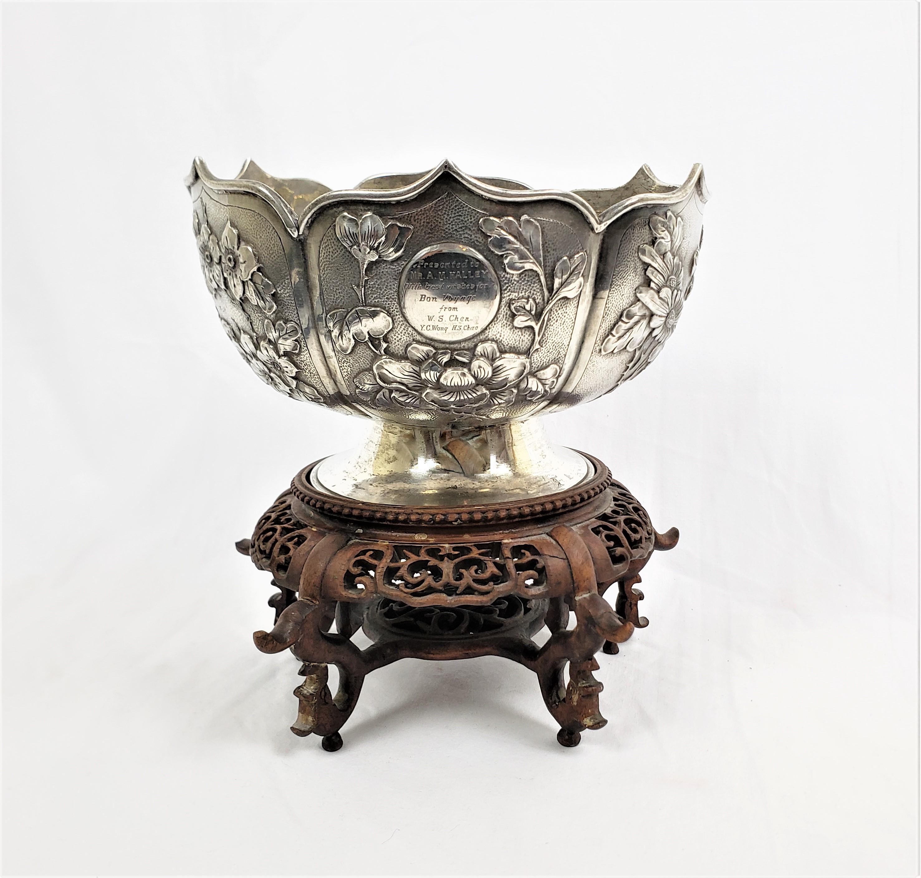 This silver bowl was made by Zee Sung of China in approximately 1910 in the period Chinese Export style. The bowl is composed of silver with six stylized petal shaped panels done with ornate chased decoration depicting birds, flowers and bamboo. The