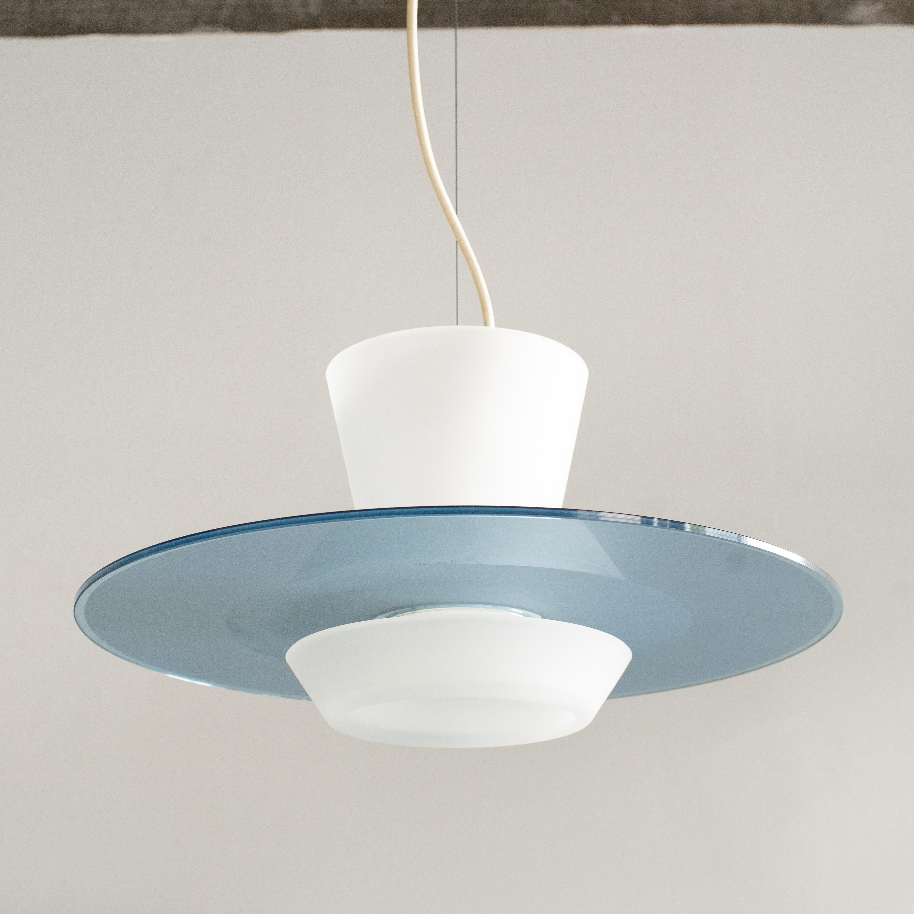 Frosted glass pendant lamp designed by Pier Giuseppe Ramella for Arteluce. It was designed in the late early 90s. Made of blue and white frosted glasses. Gentle light is shining through frosted glass. 

E26 light bulb 150W max.



