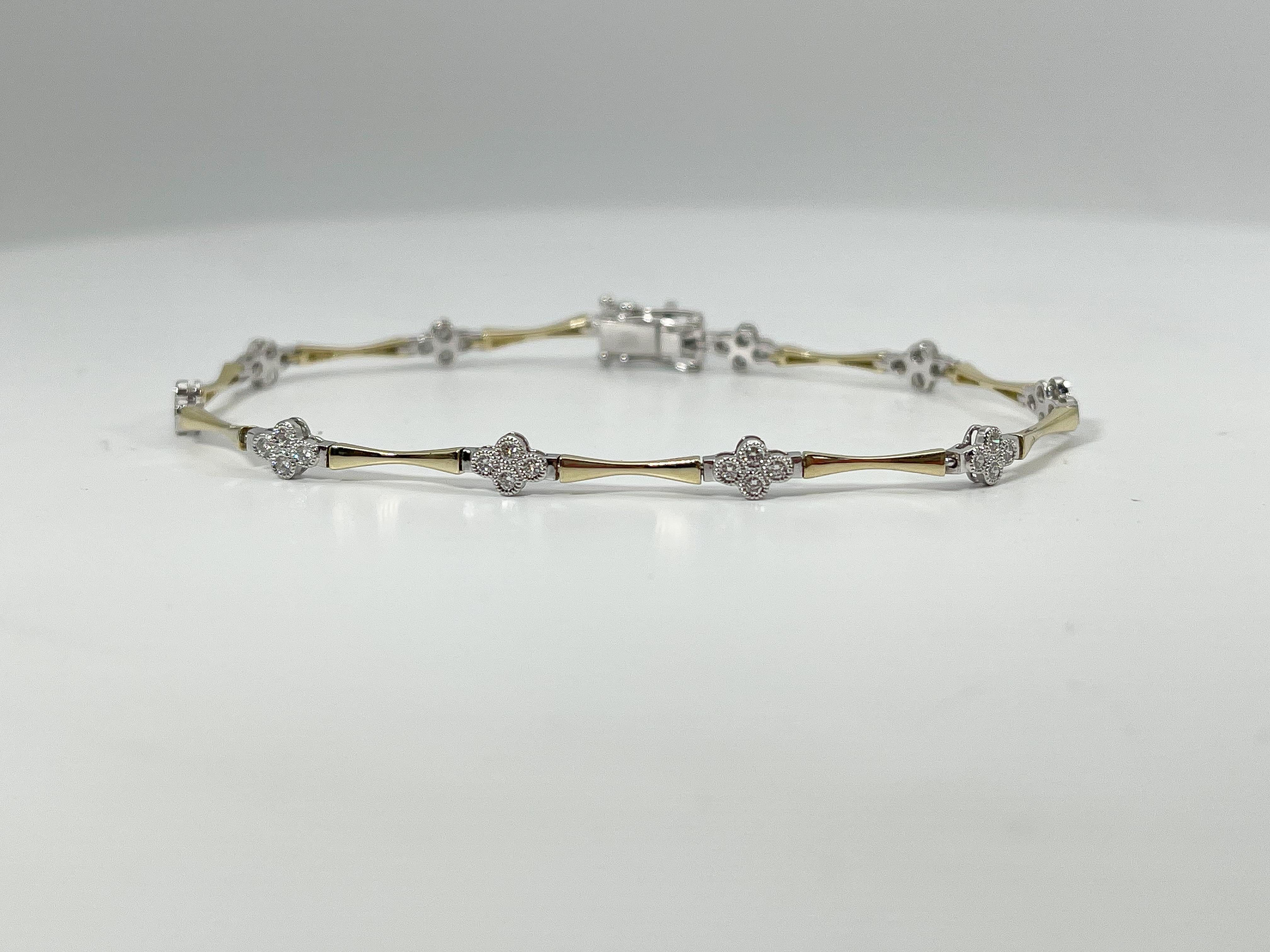 Zeghani 14k two toned .54 CTW diamond bracelet. The diamonds in this bracelet are all round, has a figure 8 clasp to open and close, the length of the bracelet is 7 inches, has a width of 4.2 mm, and it has a total weight of 5.6 grams. 