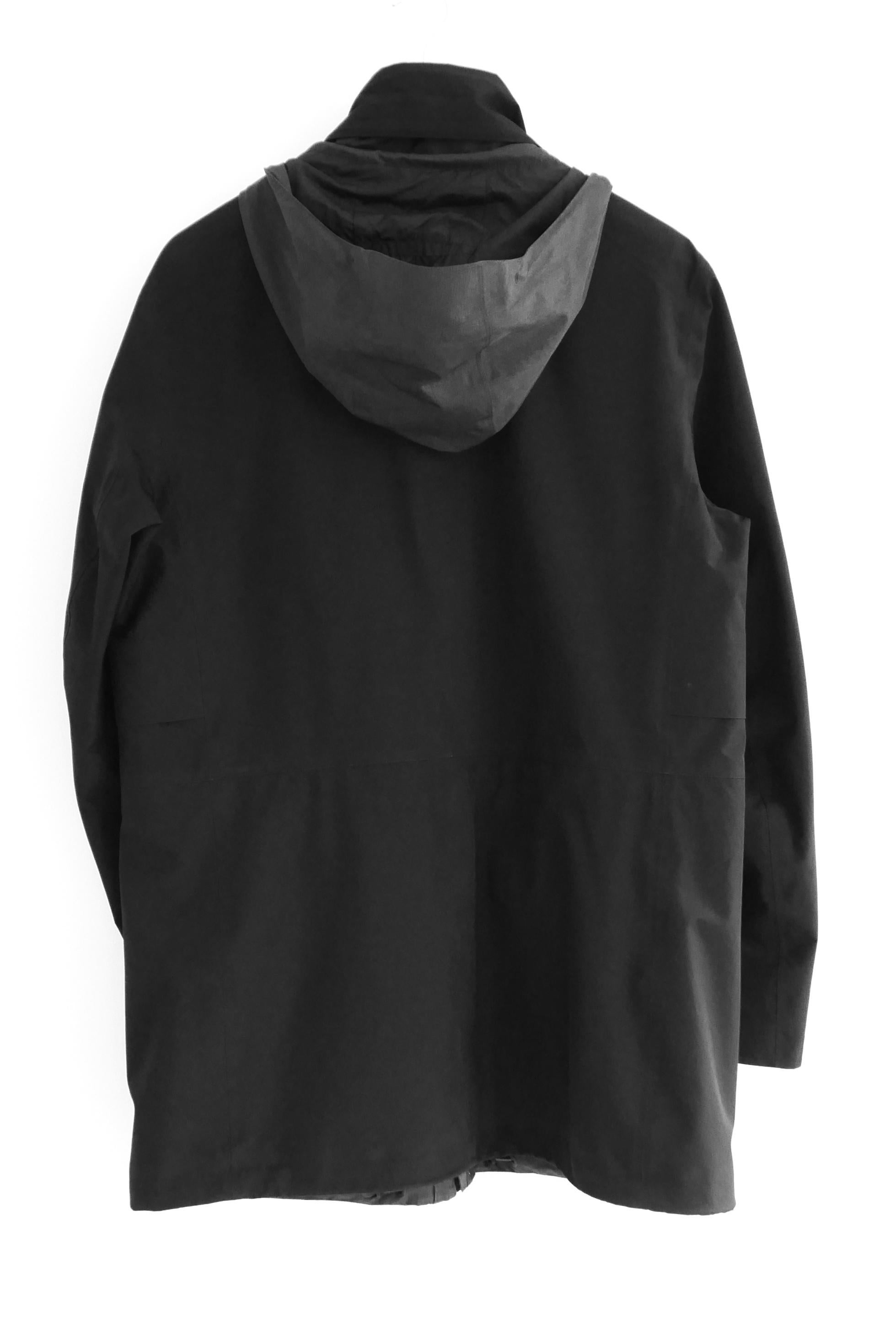 Giacca a vento e puffer 2 in 1 di Lux Zegna. Indossato una manciata di volte, viene fornito con sacchetto di polvere. È stato lavato a secco. Realizzato in poliestere Soft Shell nero, ha una giacca interna trapuntata rimovibile che può essere