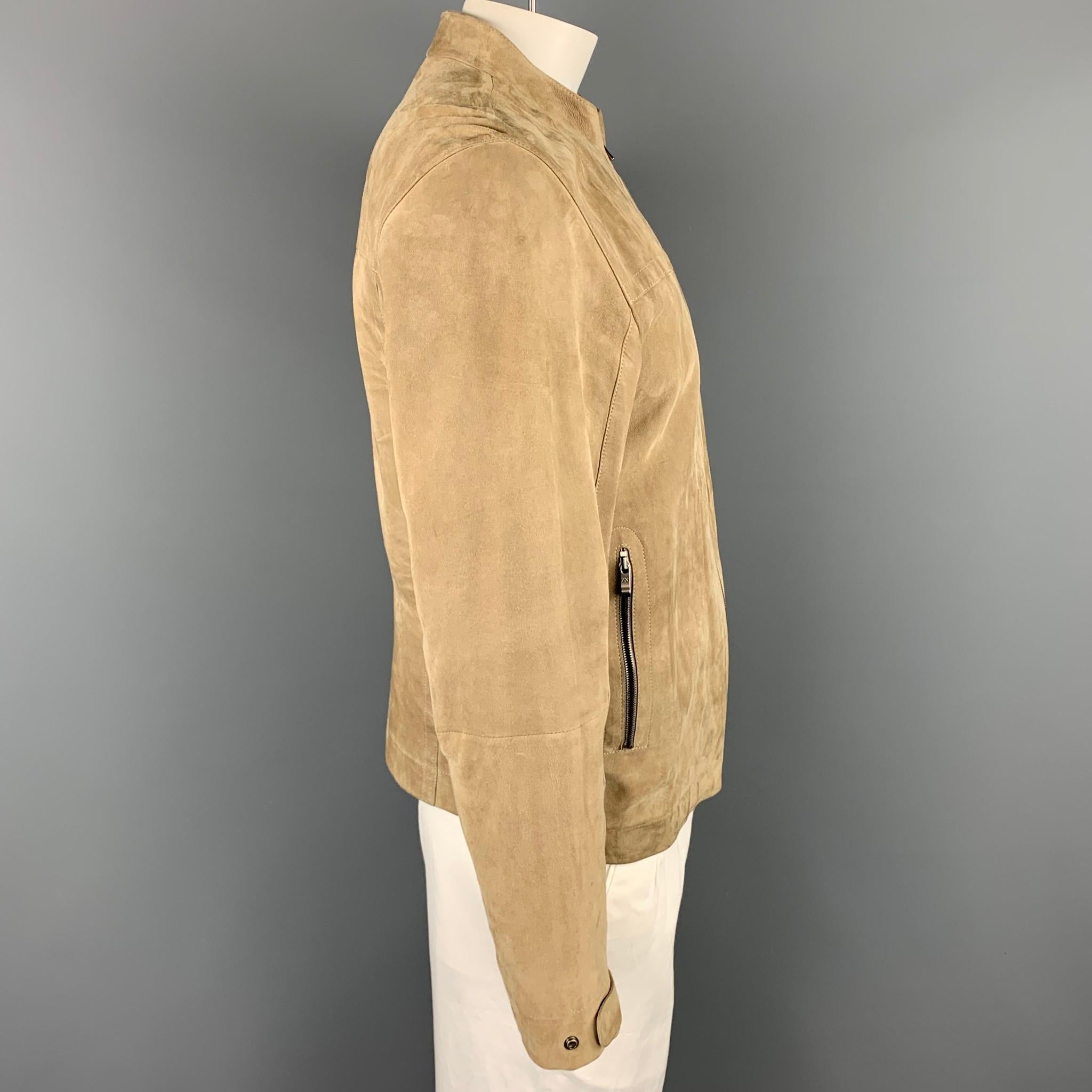ZEGNA SPORT jacket coms in a khaki suede featuring a nehru collar, top stitching, and a zip up closure. Moderate wear.

Good Pre-Owned Condition.
Marked: L

Measurements:

Shoulder: 19 in.
Chest: 41 in.
Sleeve: 26 in.
Length: 24.5 in. 