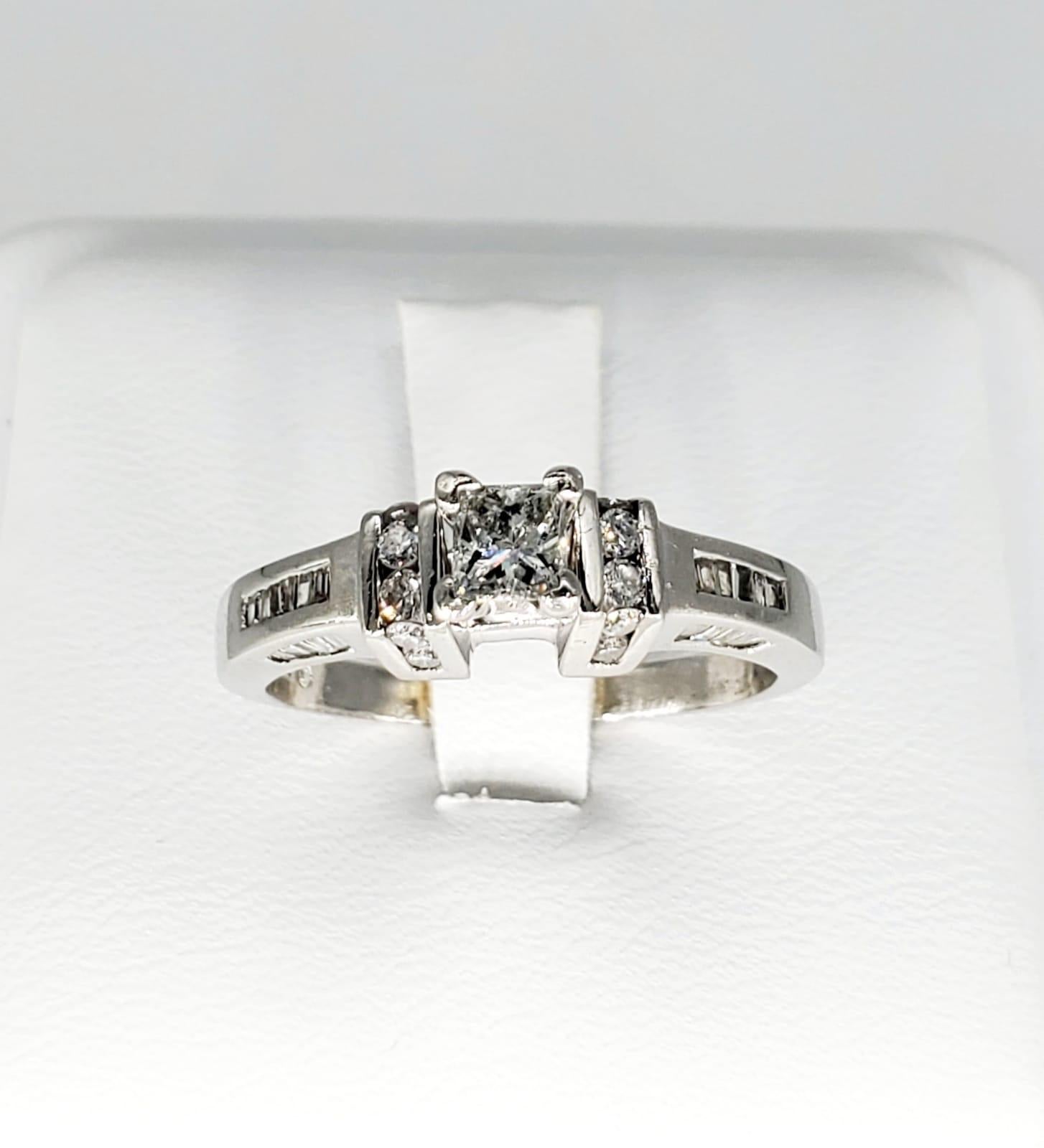 ZEI Antique 1.50 Carats Diamond Engagement Ring Platinum 900. The ring has a lot of details including most of it by channel setting the diamonds. The center diamond weights 0.50 carat and is a princess cut. The round diamonds around total weight