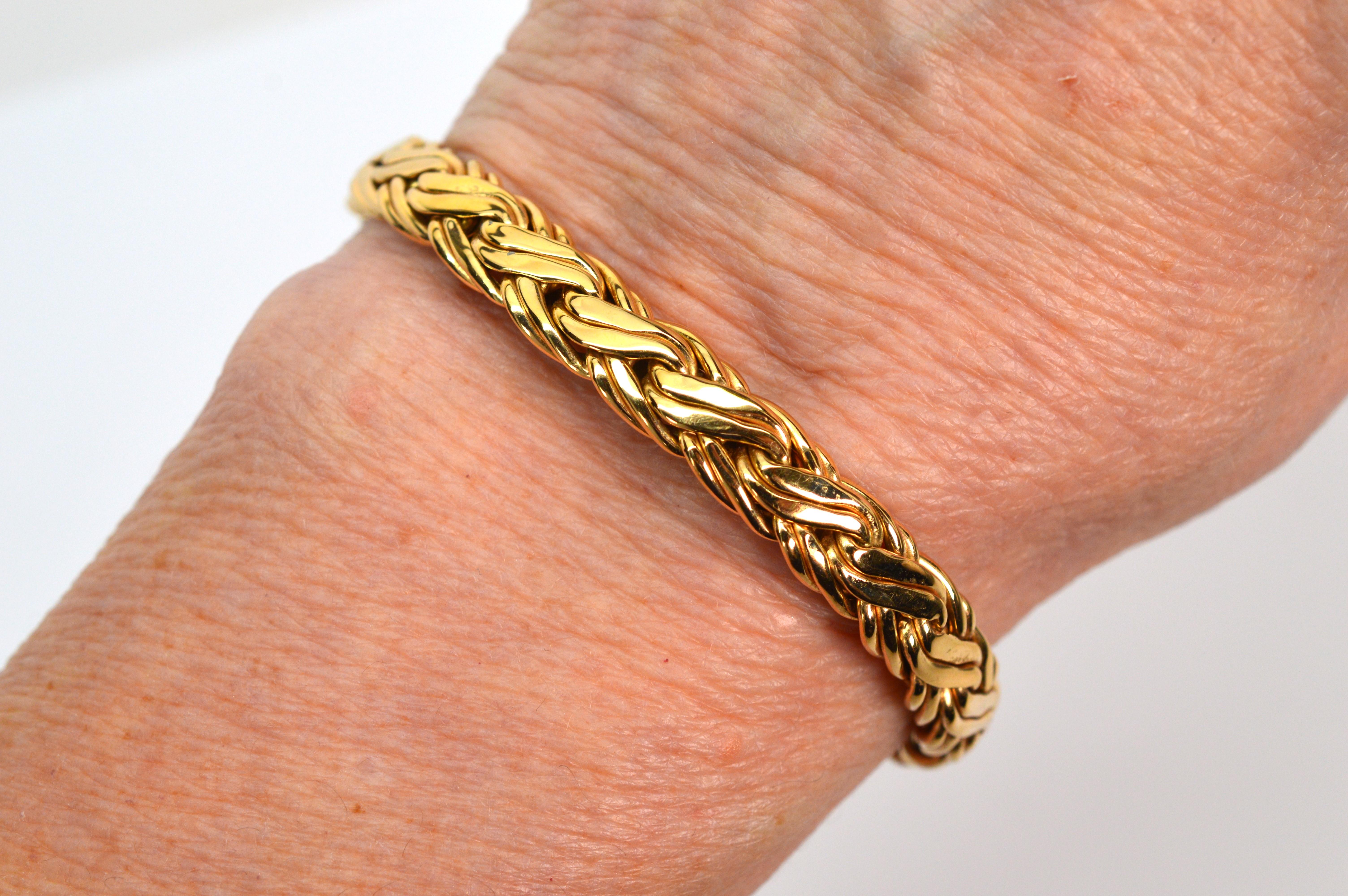 Superbly constructed in 14 karat yellow gold by known jewelers Zelman & Friedman. A fine staple piece to add to your jewelry wardrobe, this brightly polished round wheat chain bracelet is 7 inch in length and 12.5mm wide. The attractive and