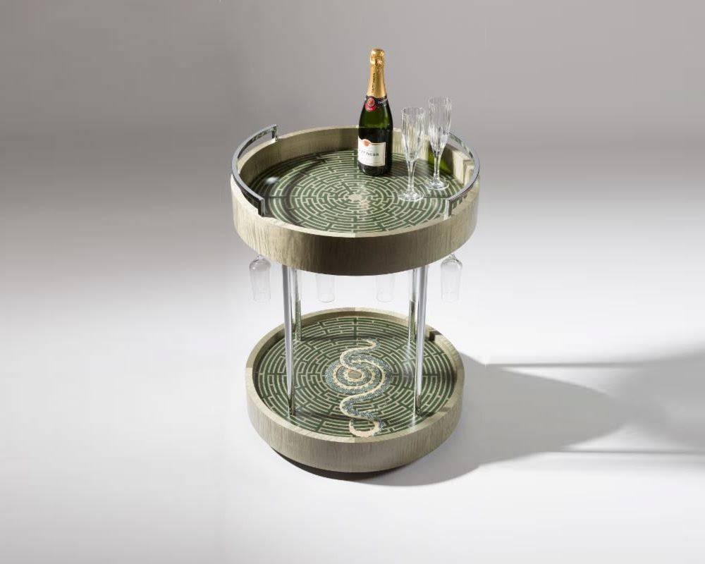 Zelouf & Bell’s Serpent in the maze champagne cart is a marvel of craftsmanship, of lush materials used in perfect concert with one another. Built on a steel frame, the piece features twin levels clad in muted shagreen. Each is topped in an