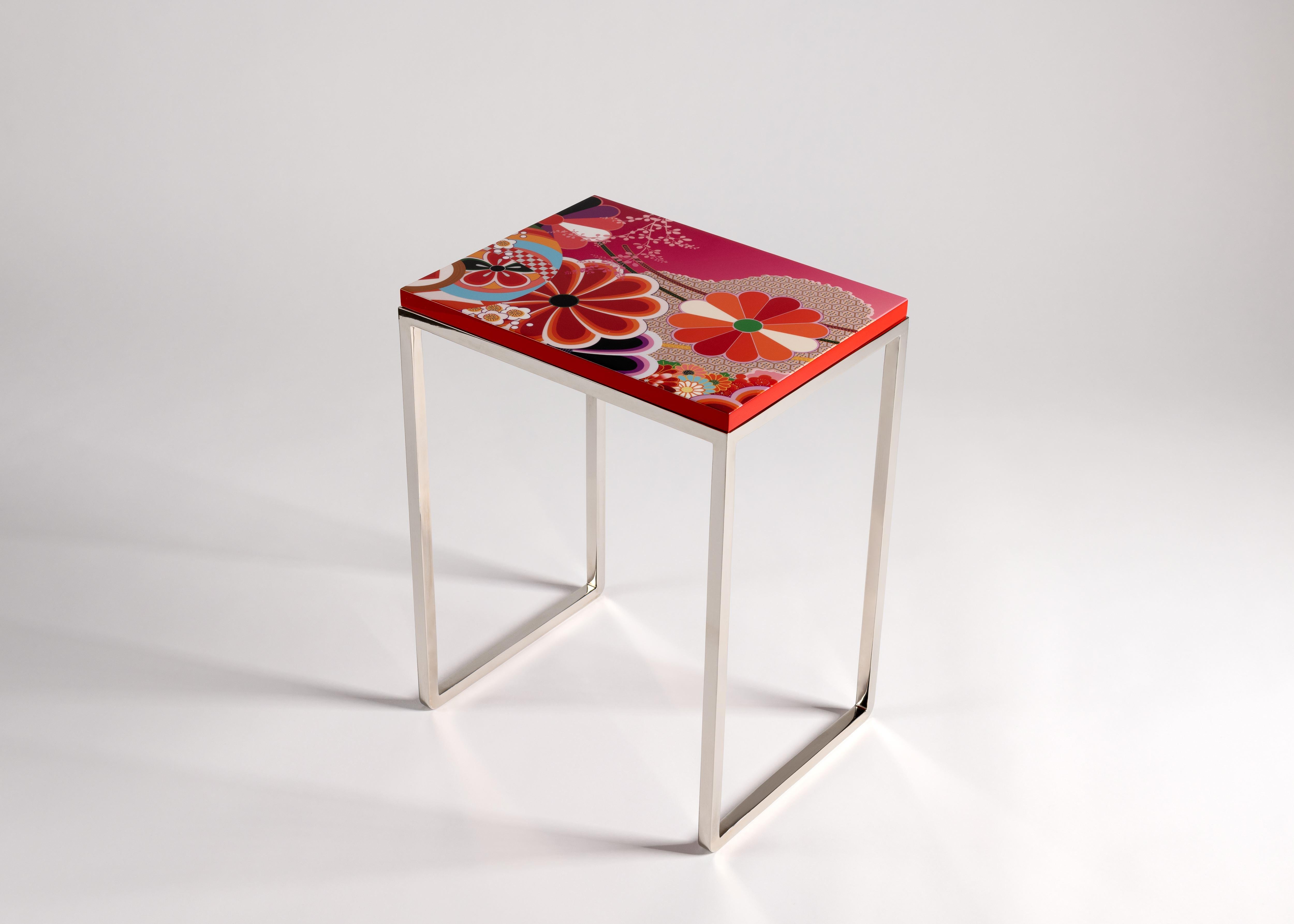 Zelouf & Bell are masters of creating refined, sophisticated custom pieces reflecting the unique needs and bespoke tastes of collectors and clients around the world.

Kiku, a lacquered side table with nickel-plated legs, is covered in a bright