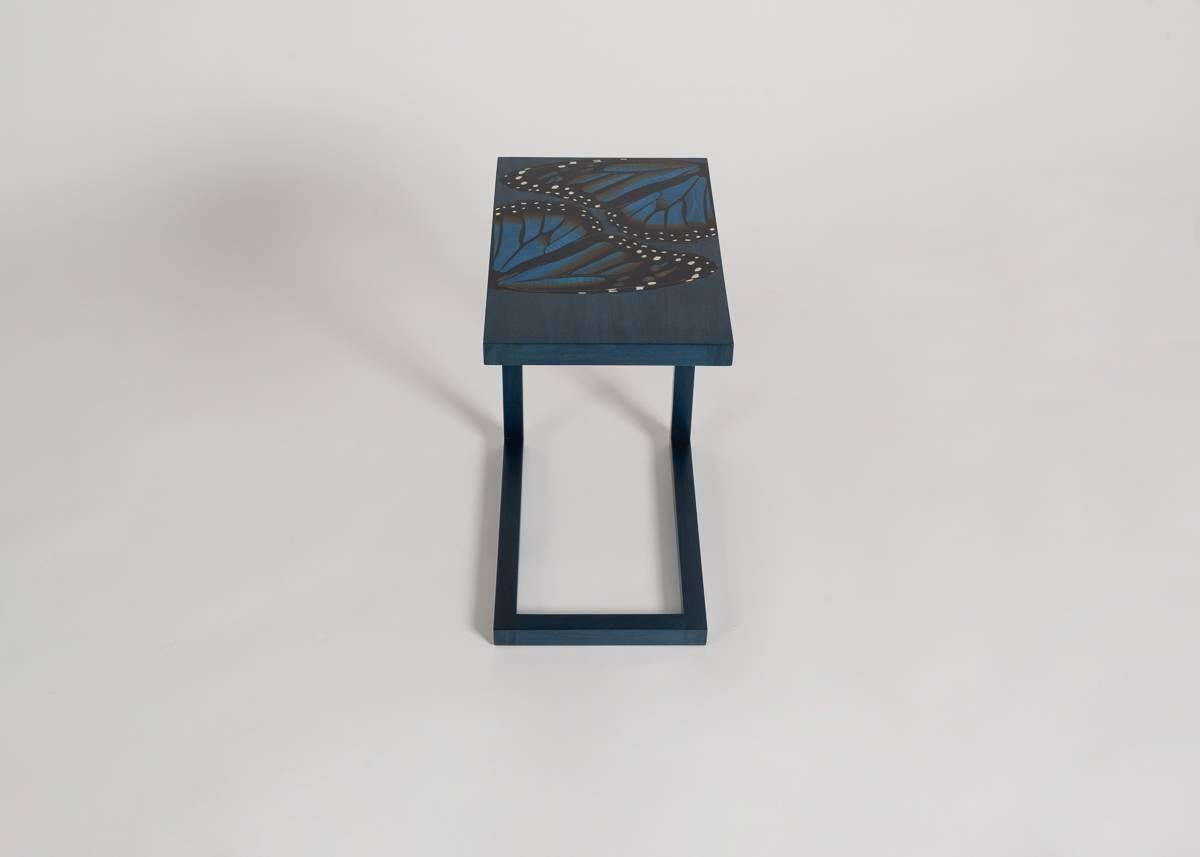 Edition of 16 + AP.

Made of solid walnut with a satin lacquer finish, these sleek, cantilevered side tables by the Irish furniture making team Zelouf + Bell feature an inlay of dyed timber (sapphire ripple sycamore, ivory anegre, gray ripple