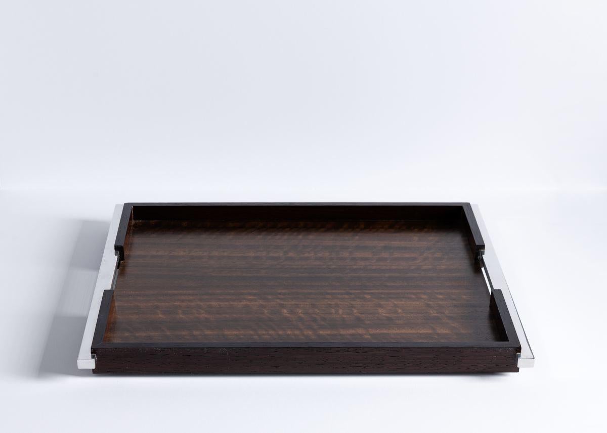 This cocktail tray is handmade from luxurious materials in our Irish workshop, featuring polished aluminium handles and a hand rubbed satin lacquer finish, inlaid discreetly with Z+B's sterling silver logo. The Makassar ebony and Wenge tray comes