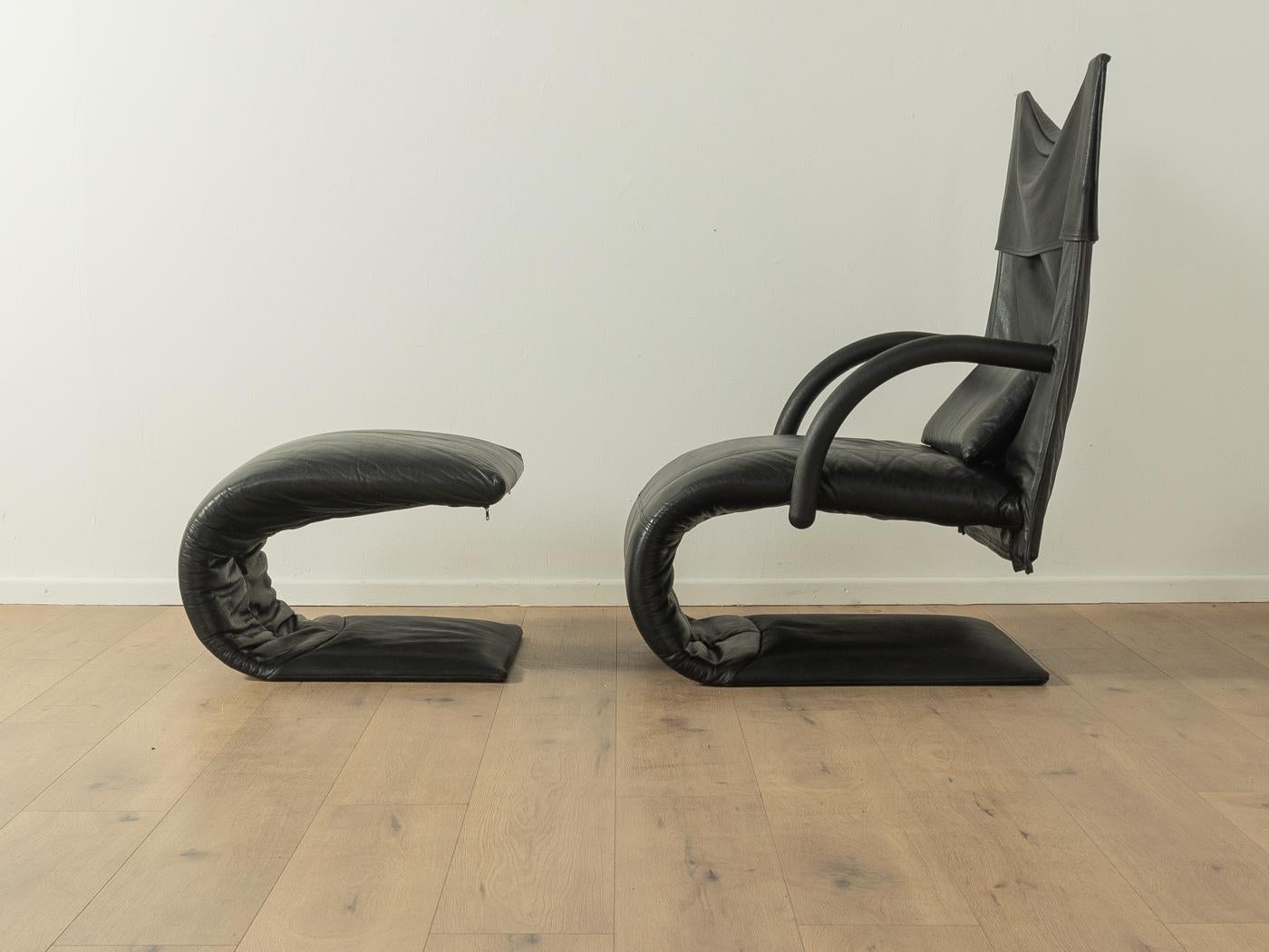 ZEN armchair with stool by Claude Brisso for Ligne Roset from the 1980s. High-quality cantilever frame made of steel with the original leather cover in black. 

Quality Features:
accomplished design: perfect proportions and visible attention to