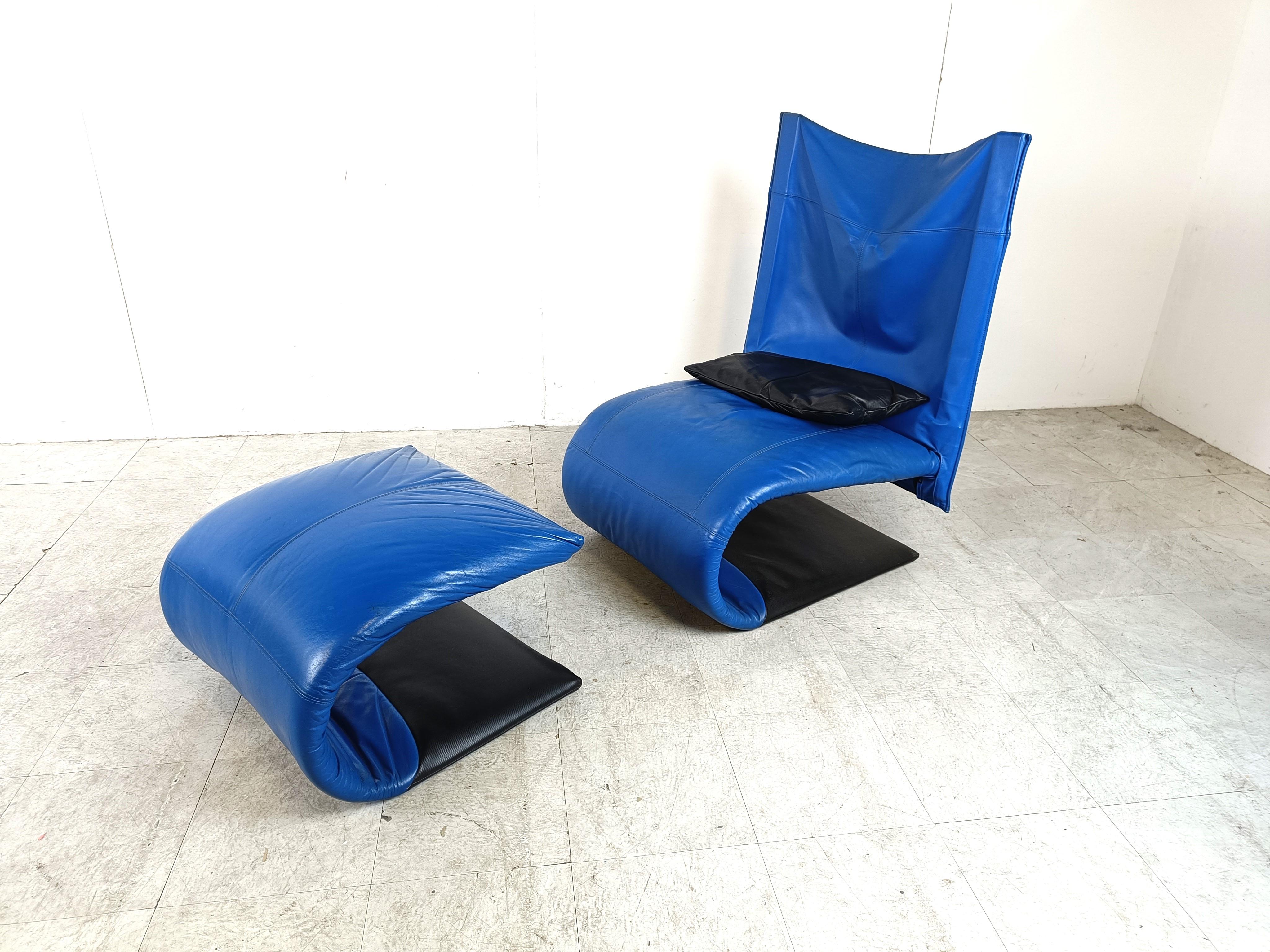 Striking black and blue leather 'Zen' lounge chair with ottoman designed by Claude Brison for Ligne Roset.

Complete with black leather cushion, this lounge sofa is very very comfortable and has a modern design.

Good condition and vibrant blue