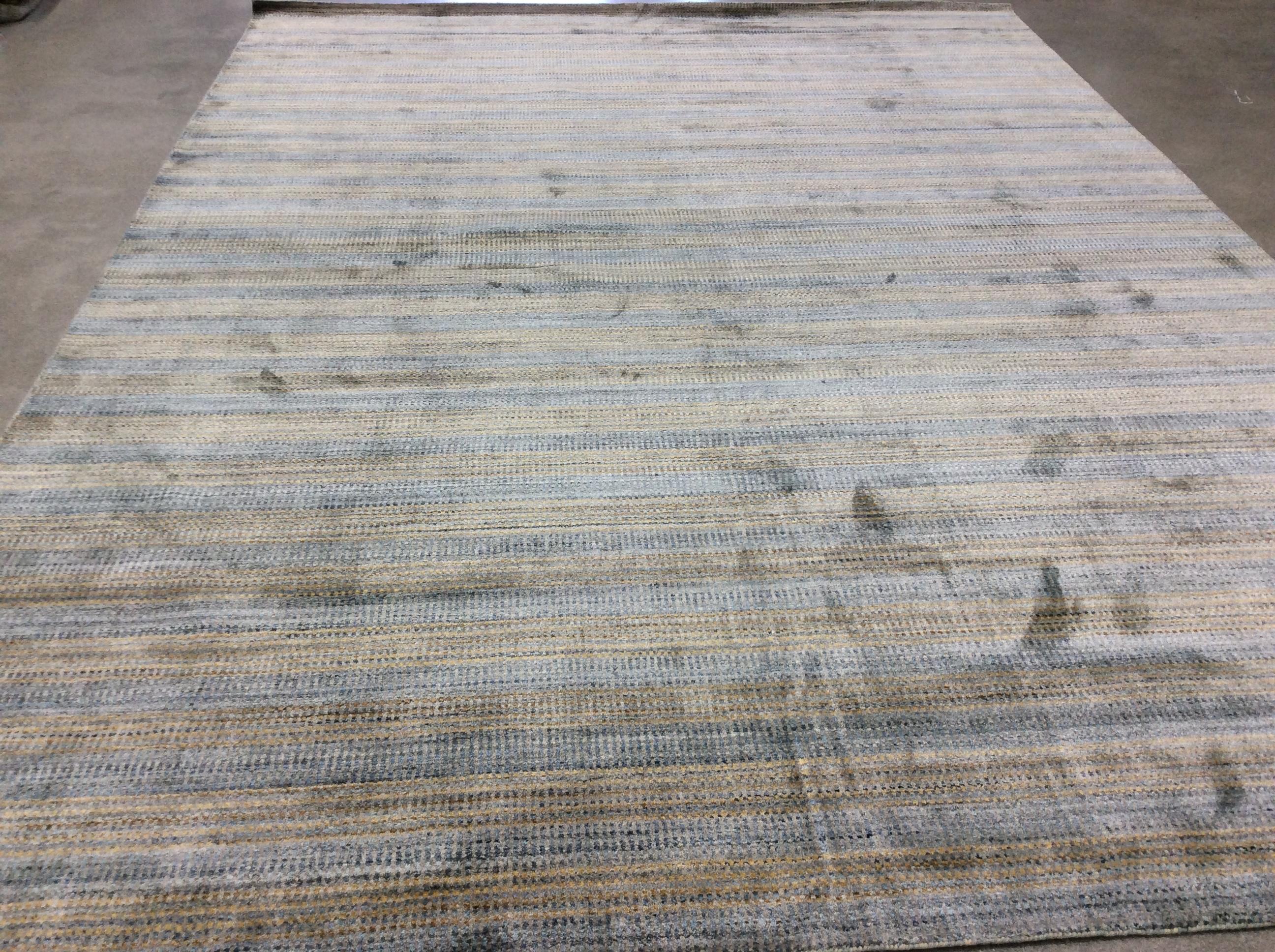 Zen collection rug in striated denim.

Intricate pattern of dots and dash all over this silky feel rug. Neutral color palette with a touch of color, dress it up or down with this subtle rug.  Wool/viscose blend for comfort and durability.  Hand made