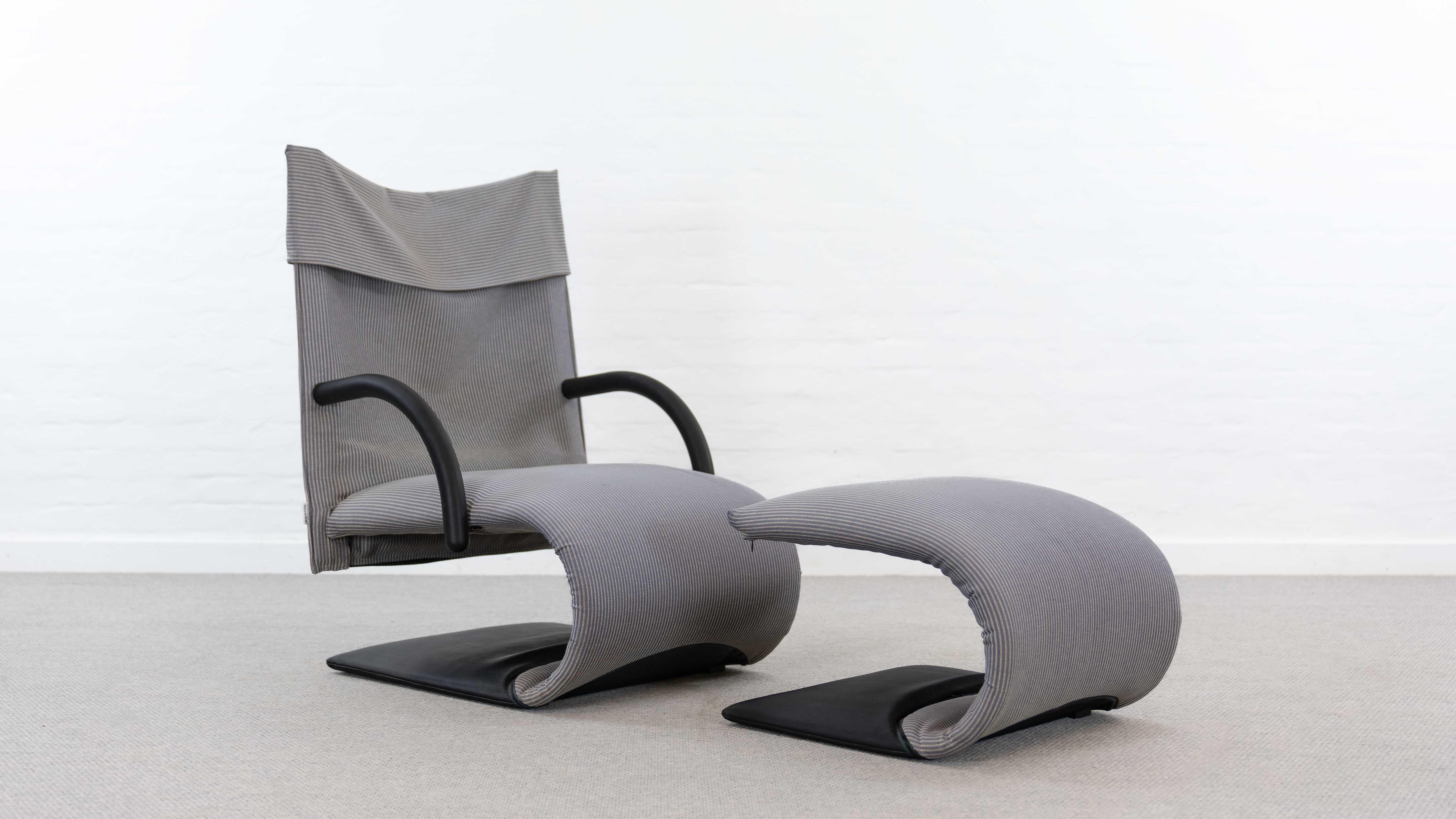 Silla Zen con reposapiés, diseñada por Claude Brisson para Ligne Roset, 1980. Tejido a rayas azul claro/blanco, marcado con la etiqueta de Ligne Roset. Signos de uso y antigüedad. Desgaste en la zona del asiento. Objeto no fumador.