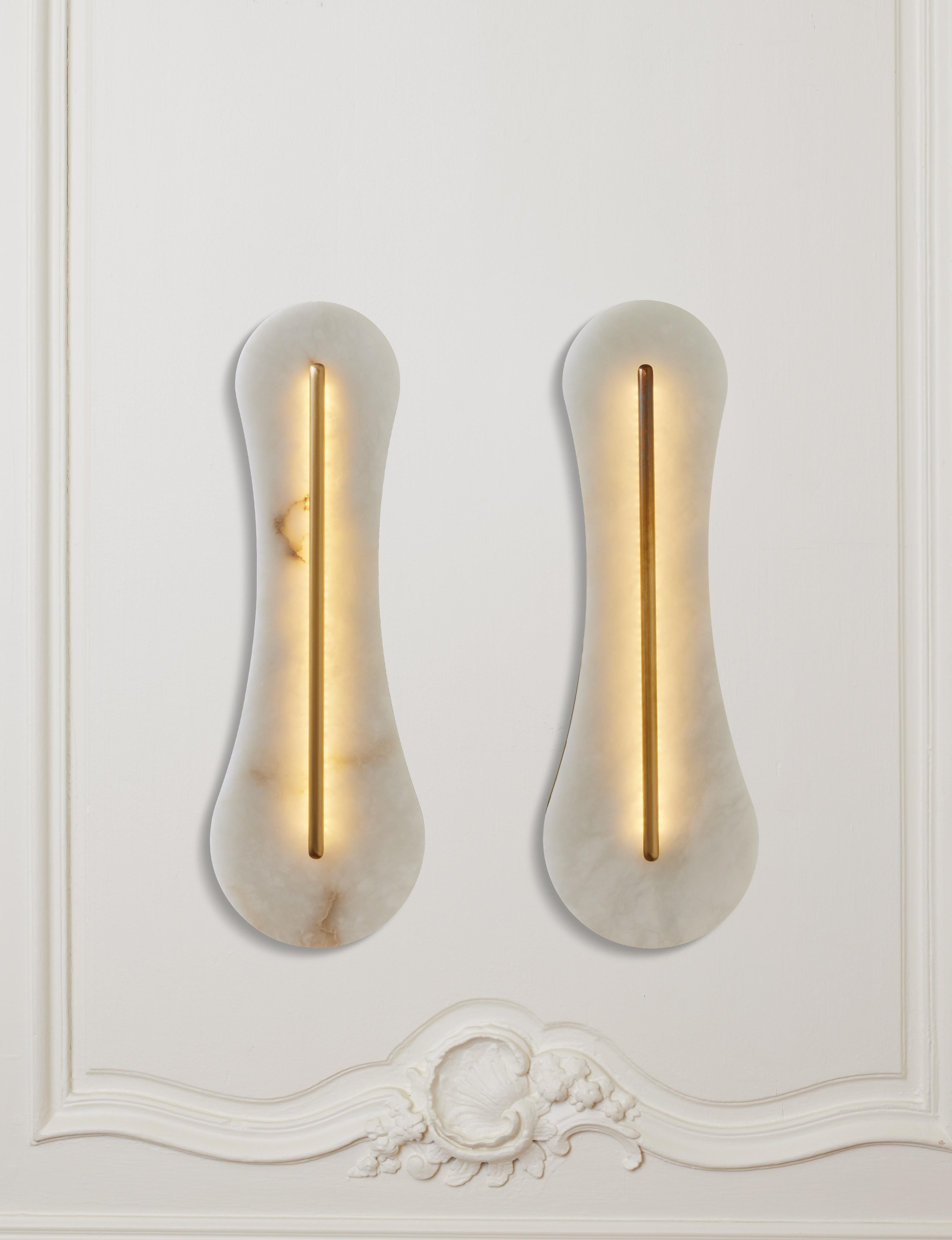 Pair of sconces in brass and sculpted alabaster.
Creation by Studio Glustin.

