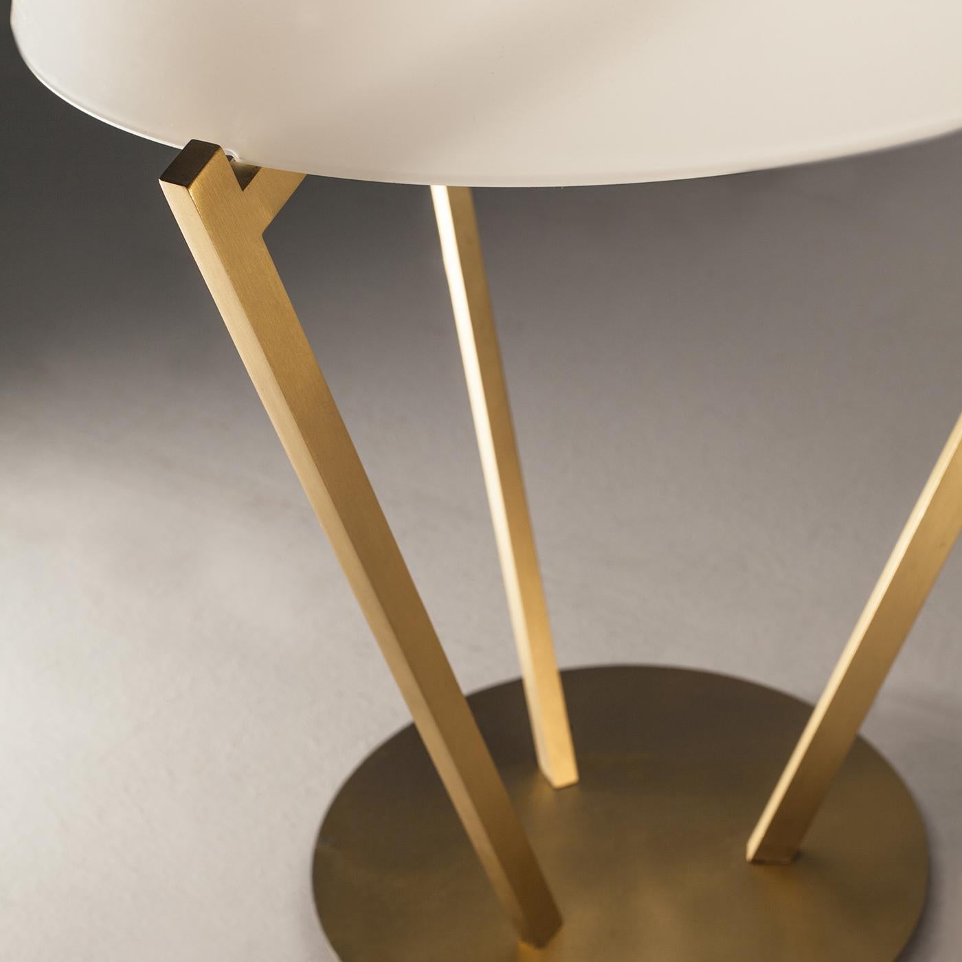 The Zena table lamp has brass structure available in light satin gold, while the diffusor is in opal glass. Measures are 20 x 20 x 36 cm; the lamp has a wall adapter with dimmer. It's perfect to give a soft light to the environment.\nLight source: