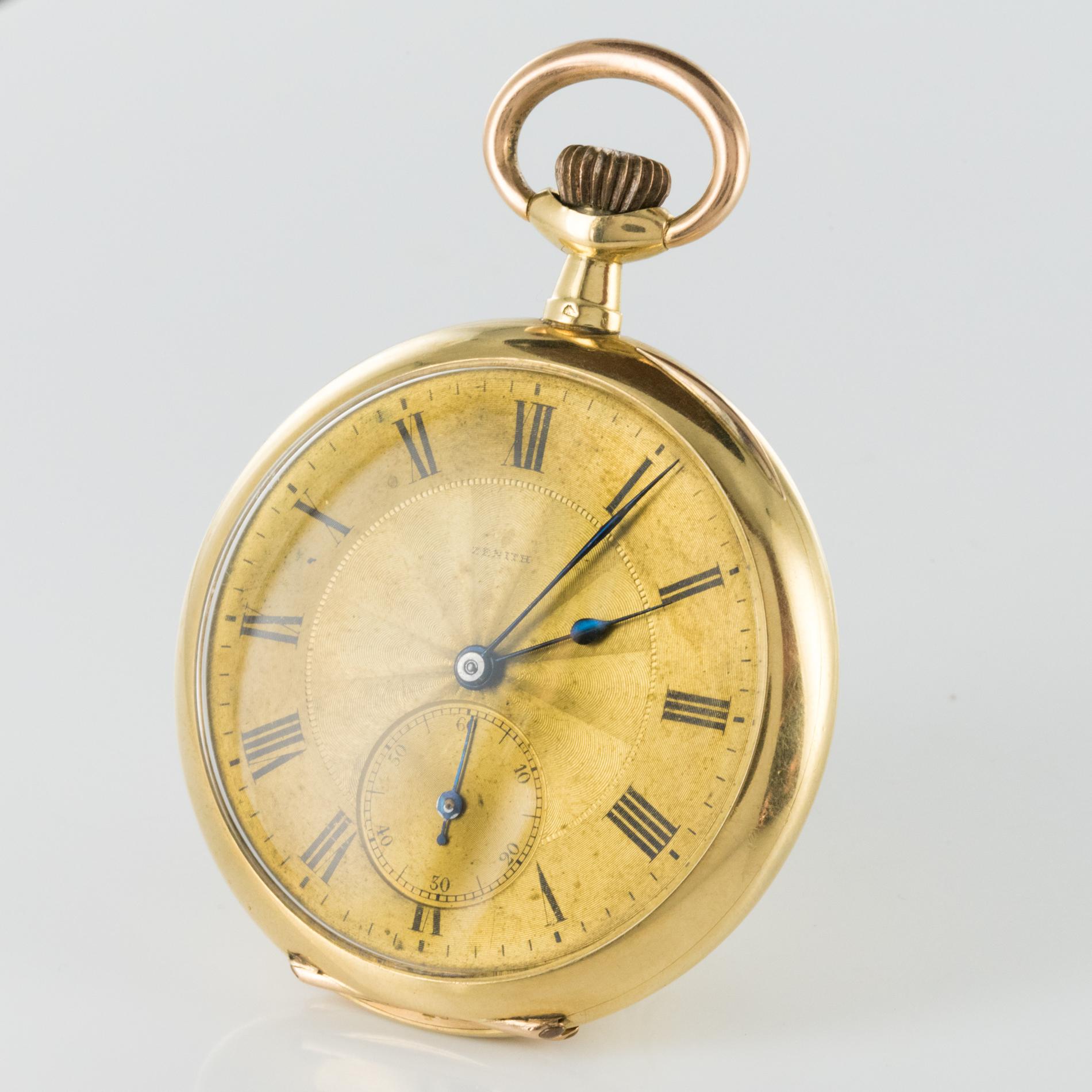 Pocket watch in 18 karats yellow and rose golds, horse's head hallmark.
Chiseled back of initials in floral decorations.
Golden background.
Roman numerals.
Small second.
Brand: Zenith.
Anchor 15 jewels.
Visible lifts double tray.
Breguet balance