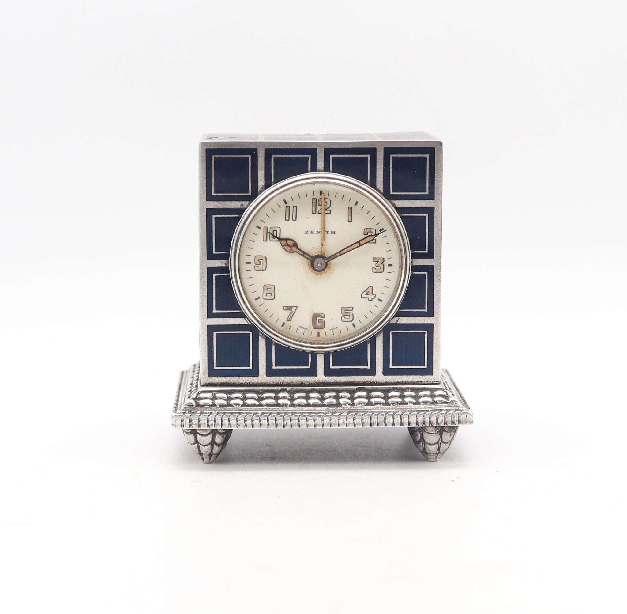 A miniature travel alarm clock designed by Zenith.

This is a gorgeous travel-carriage miniature alarm clock, made in Geneva Switzerland by the company Zenith This antique little clock is exceptional and was created during the art deco period, back