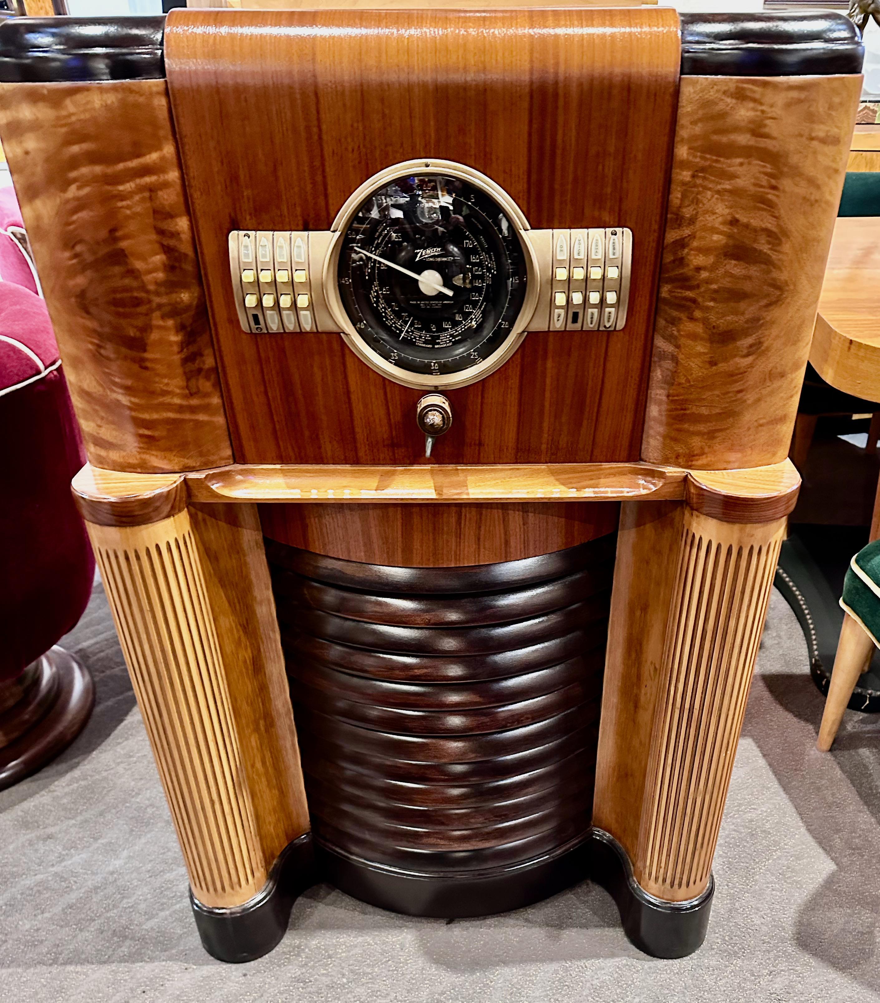 This is a 1939 Zenith 12 tube model 12S370, commonly called by collectors “Big Bertha,” one of Zenith’s most famous and collectible years. It is sporting the fabulous “Robot Shutter Dial” and a green tuning eye tube. It is one of the largest radios