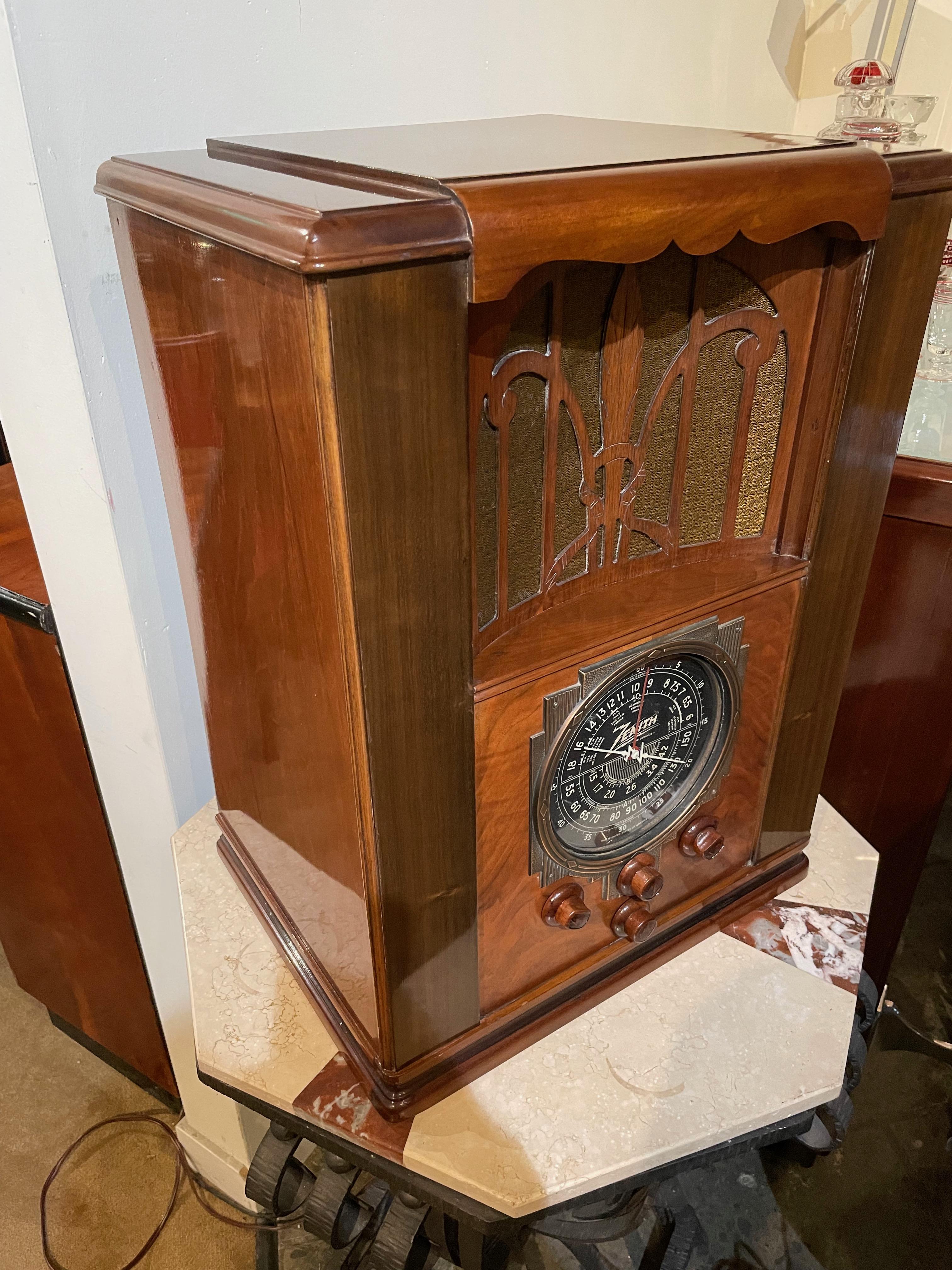 1936 Zenith tombstone model 6-S-27. The radio is a spectacular combination of angles and veneers, with the iconic multi-colored and oversized dial. This radio is one of the large tombstone cabinets offering a full range 8-inch speaker and a