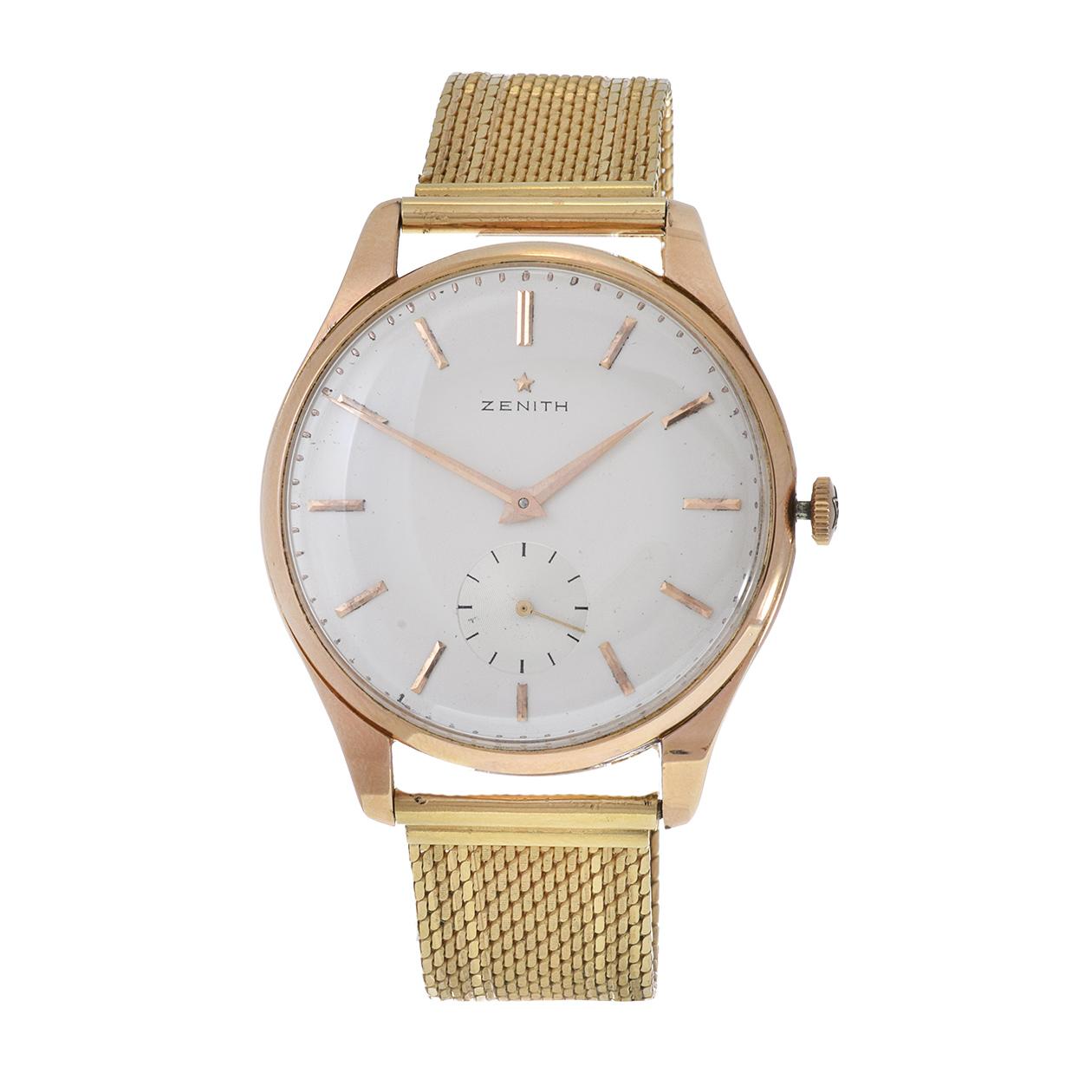 Indulge in timeless elegance with our Vintage 1960s Zenith 38mm 18KT Gold Case and Bracelet Watch. This classic timepiece features a Zenith caliber 40 17 jewel manual wind movement, a champagne dial adorned with gold stick markers, and a sub-dial