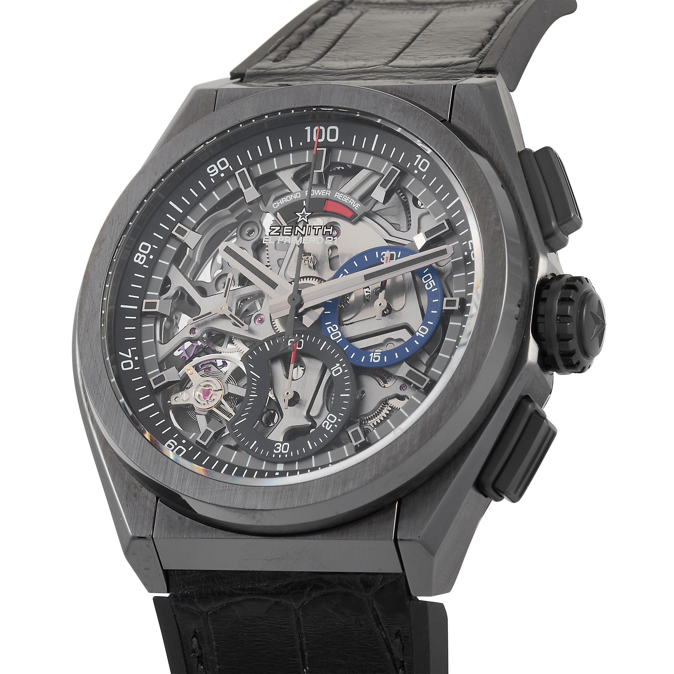 This Zenith Defy El Primero 21 Black Ceramic Watch, reference number 49.9000.9004/78.R582, features a black ceramic case that measures 44 mm in diameter. It is presented on a black leather strap with deployment clasp. The transparent case back