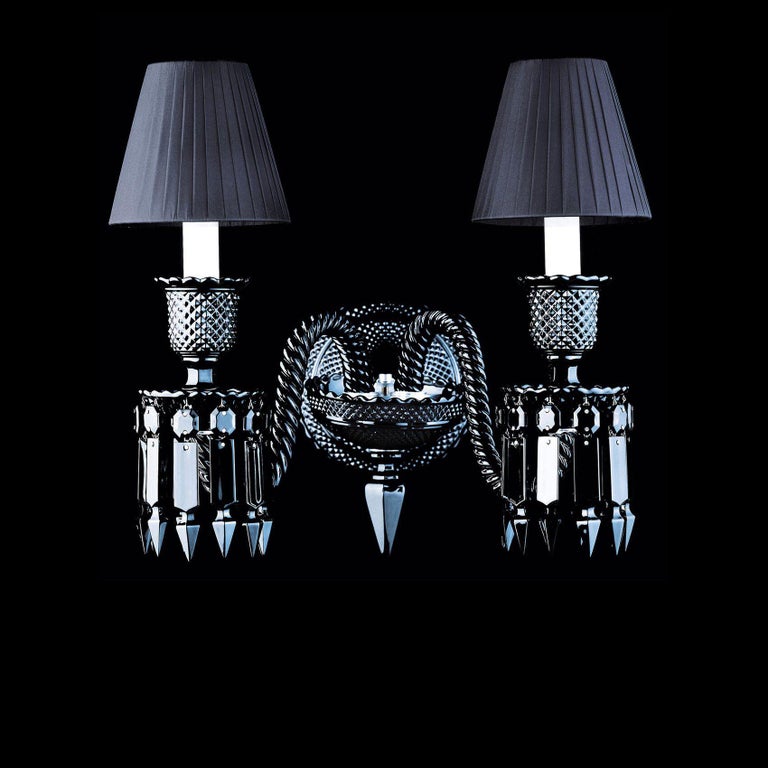 Philippe Starck has restyled the Baccarat Zénith collection with his usual talent, reverting to the tradition of black crystal—a shade that reveals the power and sculptural dimension of this emblematic creation. This two-light sconce comes with
