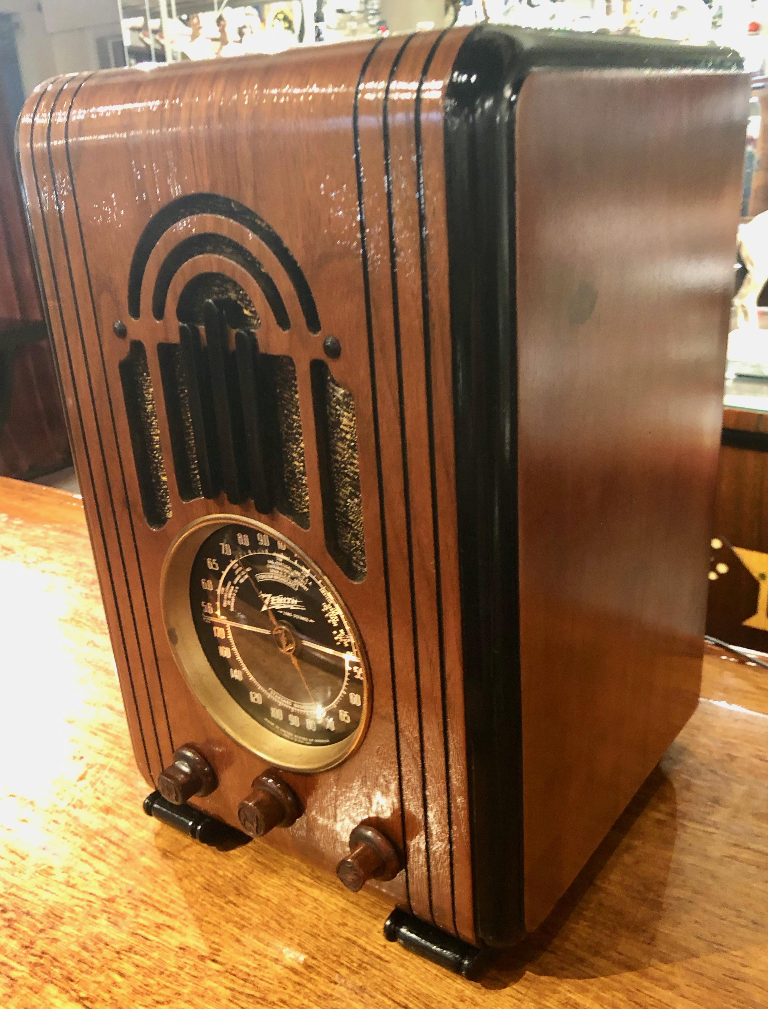 The 1937 Art Deco Zenith 5S228 is a small 5-tube AC tombstone or upright style radio. The sound is great, really loud and clear. It receives the broadcast band and one short wave band. It also has an installed jack to be able to hook up to computer,