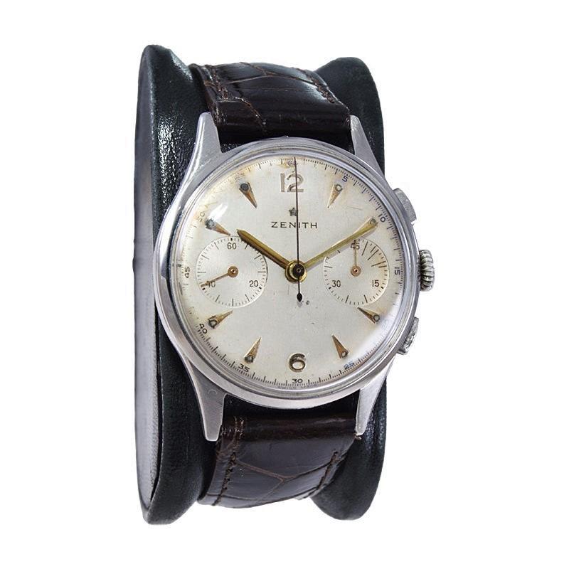 FACTORY / HOUSE: Universal / Zenith Watch Company
STYLE / REFERENCE: 2 Register Chronograph / 
METAL / MATERIAL: Stainless Steel
CIRCA: 1940's
DIMENSIONS: Length 43mm X Diameter 35mm
MOVEMENT / CALIBER: Manual Winding / Jewels / Cal. 146D (by